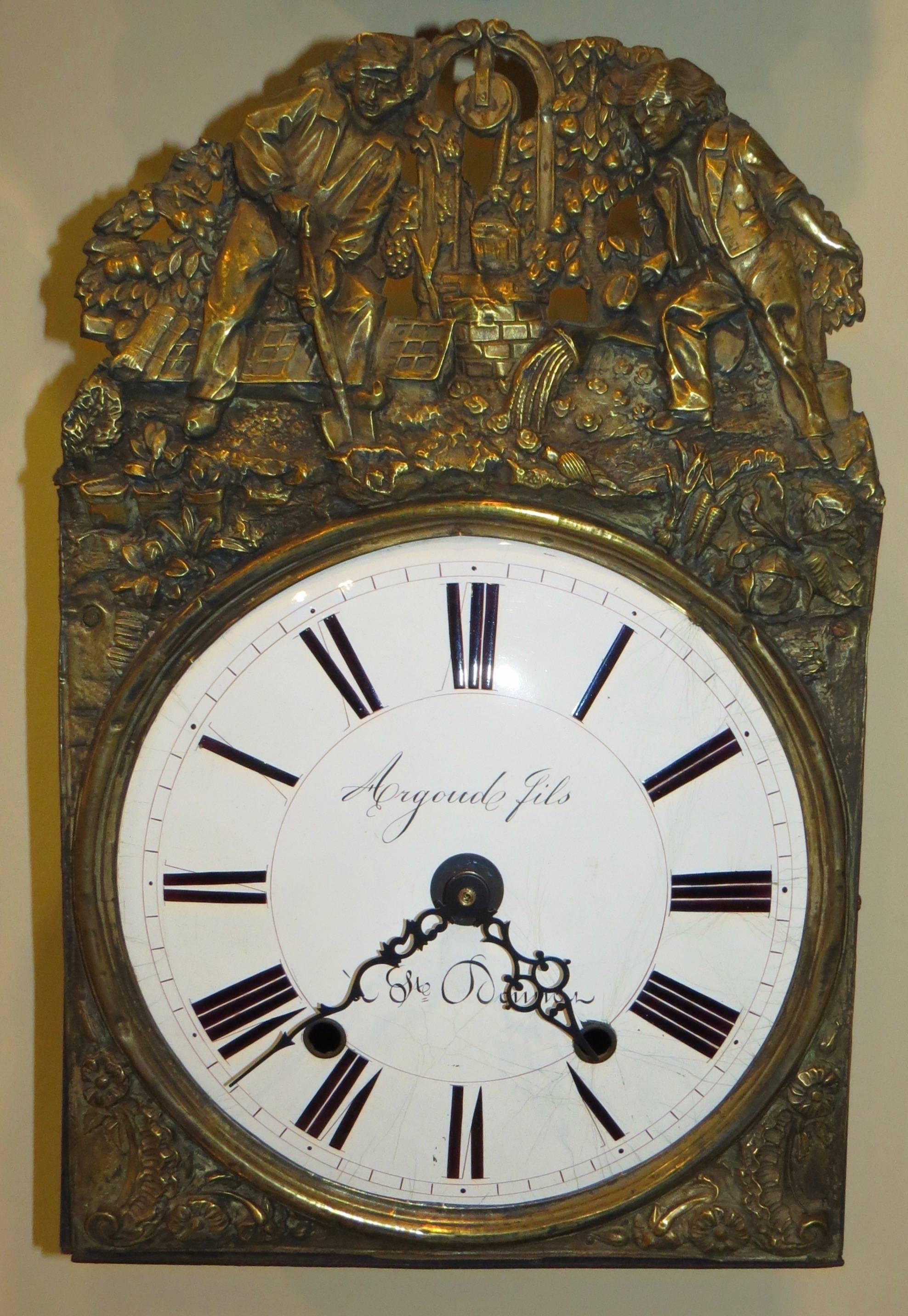 The 19th century repousse clock face decorates the housing of a new, quartz mechanism. It can hang on the wall or sit on a stack of books.