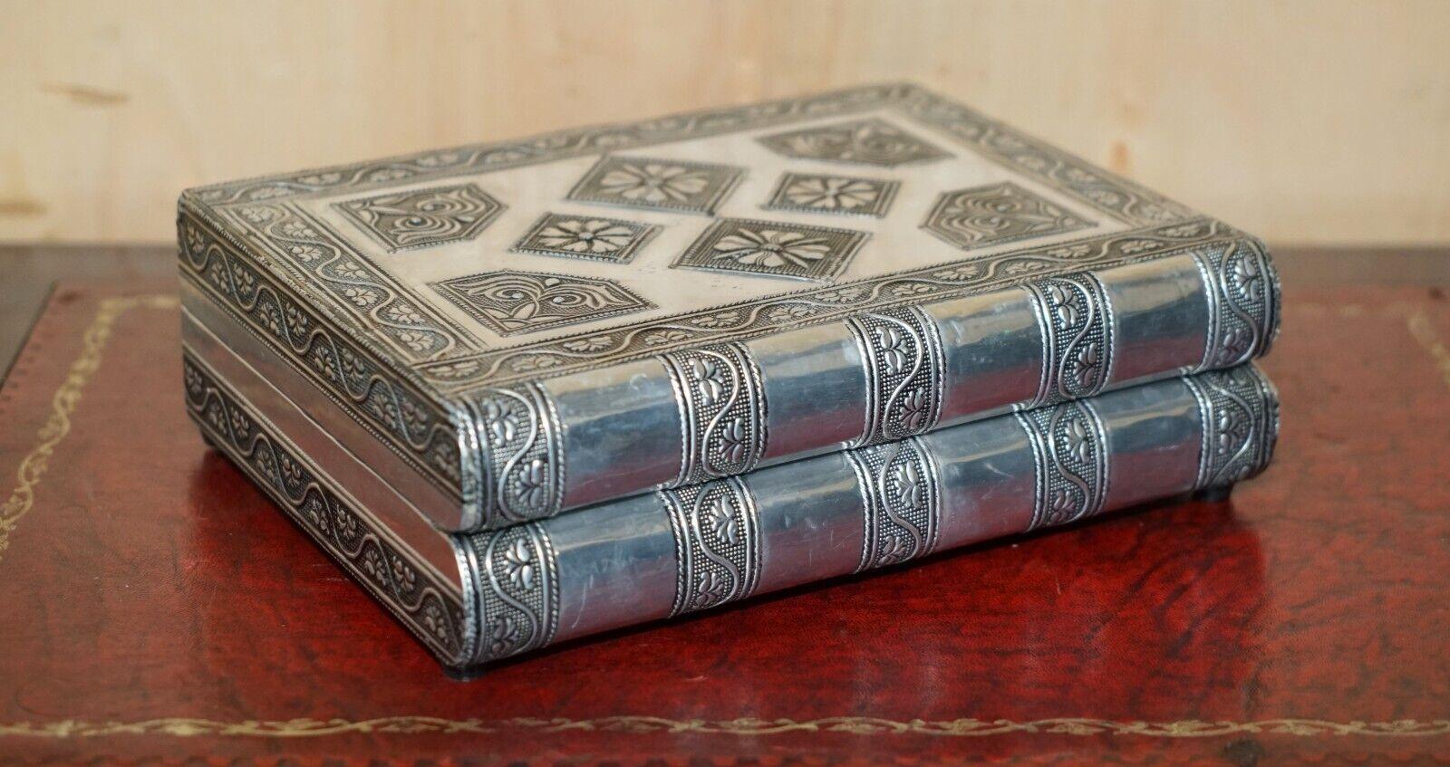 Royal House Antiques

Royal House Antiques is delighted to offer for sale this very decorative Indian Silver, stack of books which opens up to reveal a hidden jewellery box

A very good looking and decorative piece, it looks to be unused and works