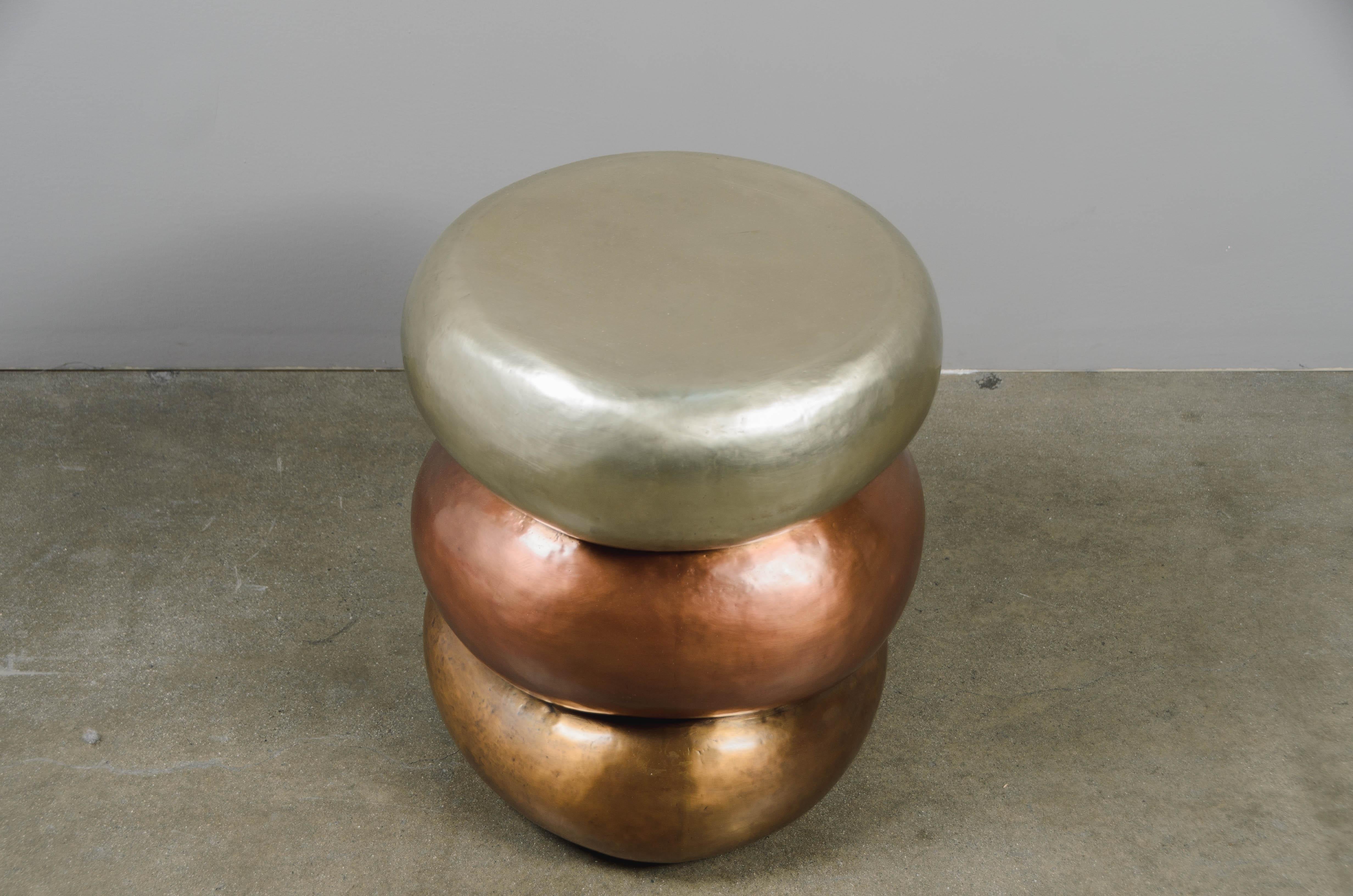 Triple Stacked Drumstool 
White Bronze, Copper and Brass
Hand Repoussé
Limited Edition
Each piece is individually crafted and is unique. 

Repoussé is the traditional art of hand-hammering decorative relief onto sheet metal. The technique originated