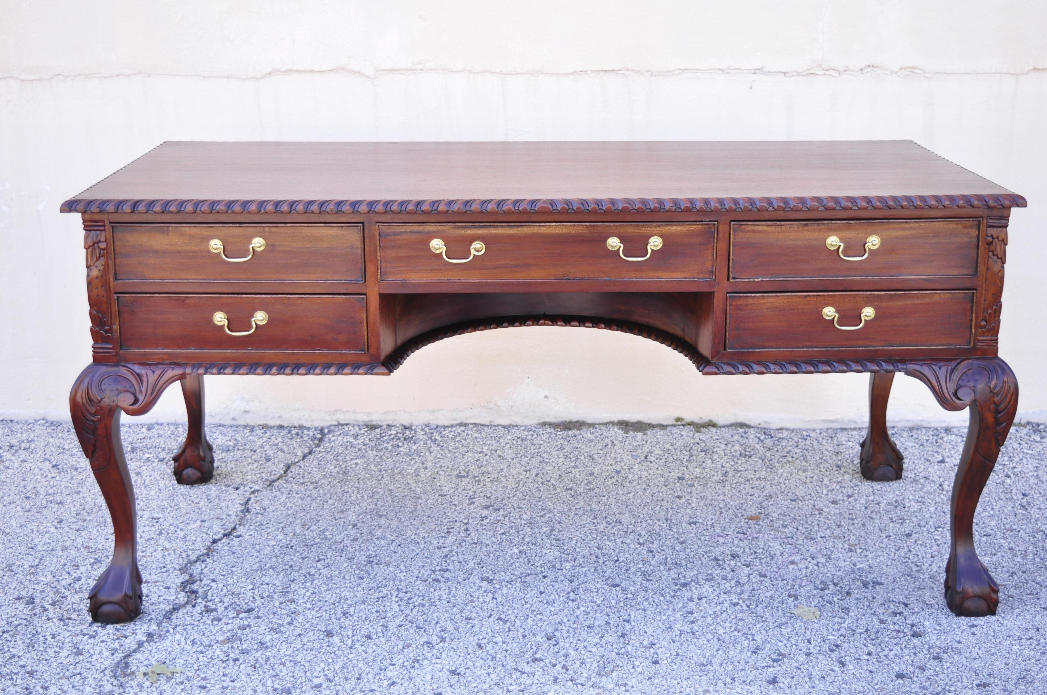 Reproduction English chippendale style mahogany ball & claw carved executive writing desk. Item features nice large size, rope carved edge, solid wood construction, beautiful wood grain, finished back, 5 dovetailed drawers, carved ball and claw