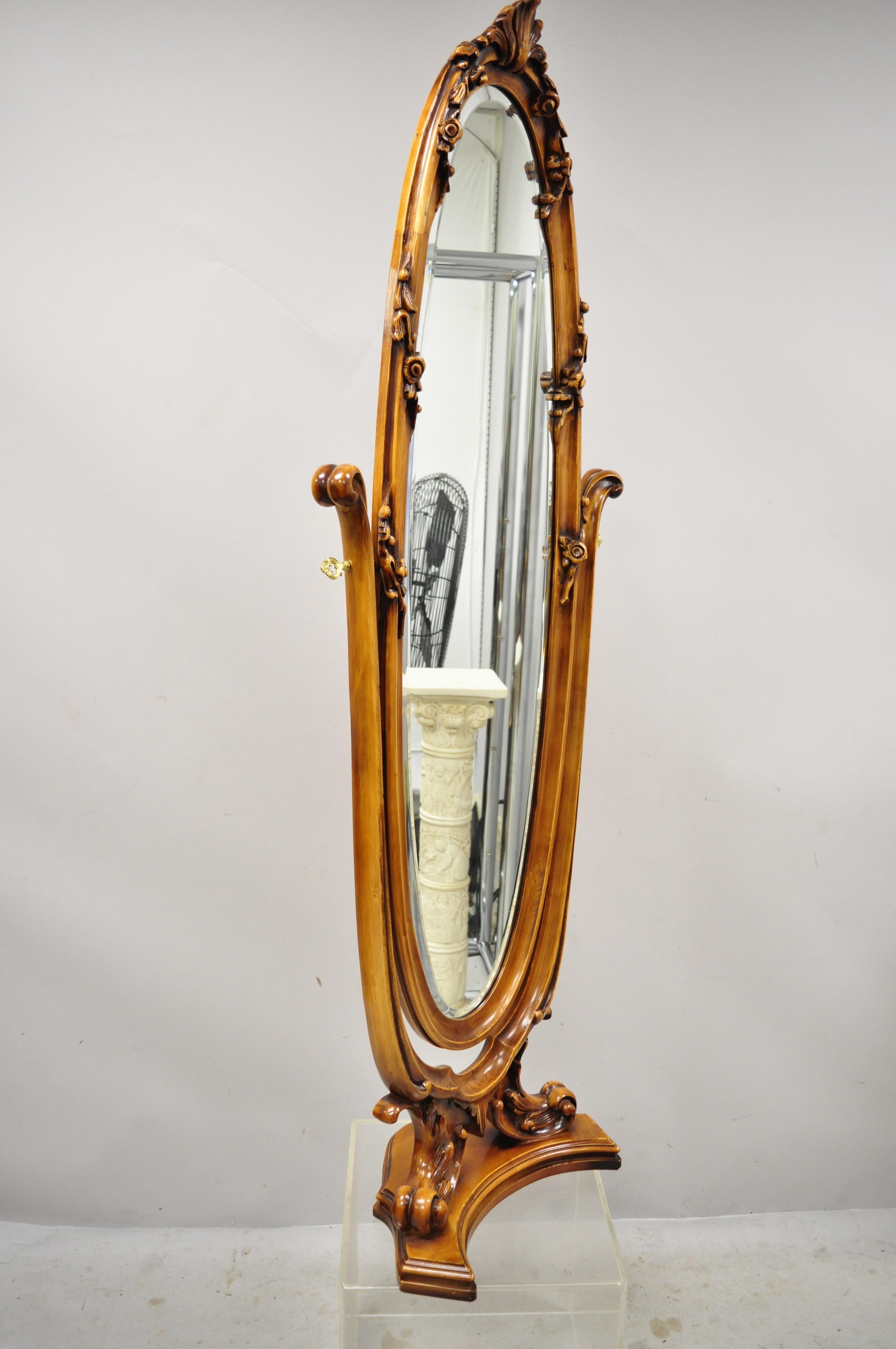 Reproduction French Victorian style carved wood oval beveled glass standing floor dressing cheval mirror. Item features nice mid-size cheval mirror, solid wood frame, beautiful wood grain, nicely carved details, oval beveled glass, great style and