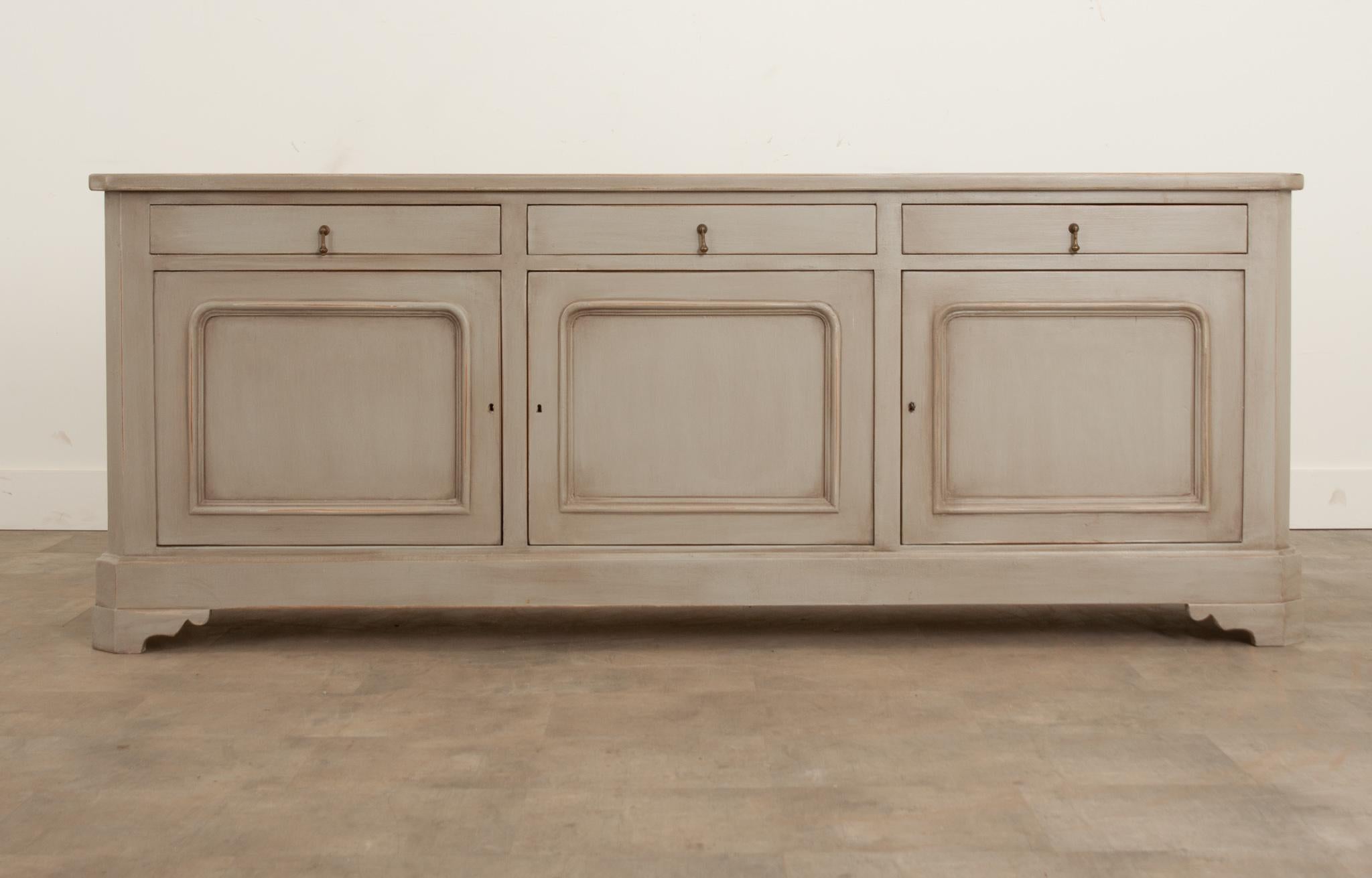 This Louis Philippe style enfilade was recently built at Fireside Antiques. Its faux worn painted finish gives it a wonderfully authentic feel. The whole features canted edges. The apron houses three equally sized, slim drawers with matching demure