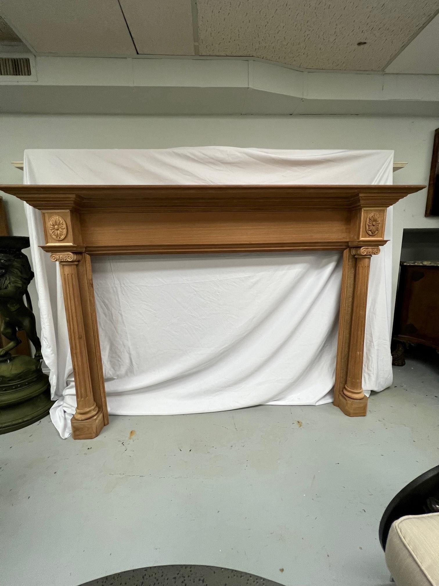 Reproduction wood fireplace mantel with fluted columns and carved capitals. Copied from an antique wood fireplace mantel sent to China before Corvid. This is a nice reproduction fireplace mantel made of Philippine mahogany and would look great