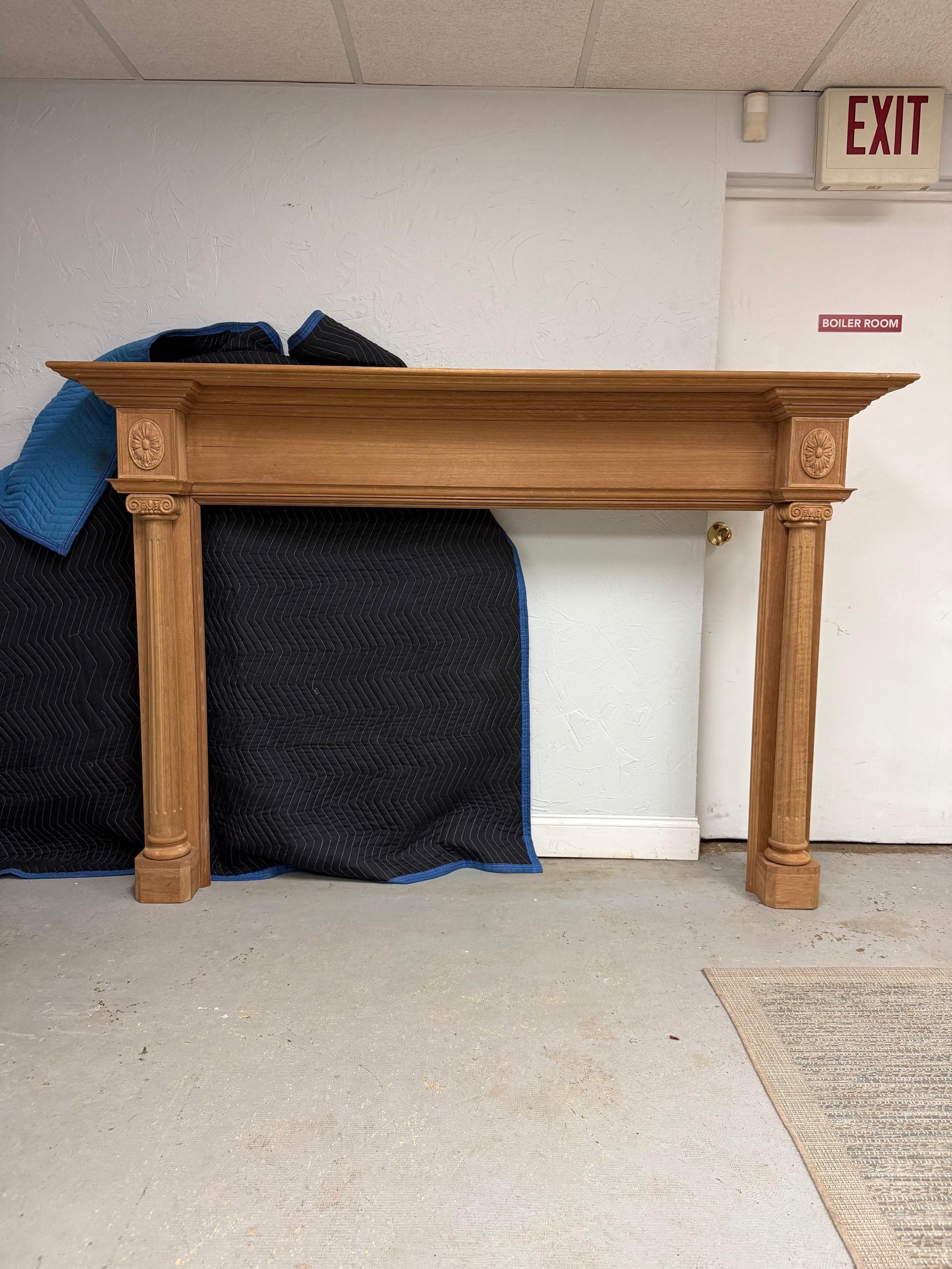 Reproduction wood fireplace mantel with fluted columns and carved capitals. Copied from an antique wood fireplace mantel sent to China in 2010. This is a nice reproduction fireplace mantel made of Philippine mahogany and would look great stained or