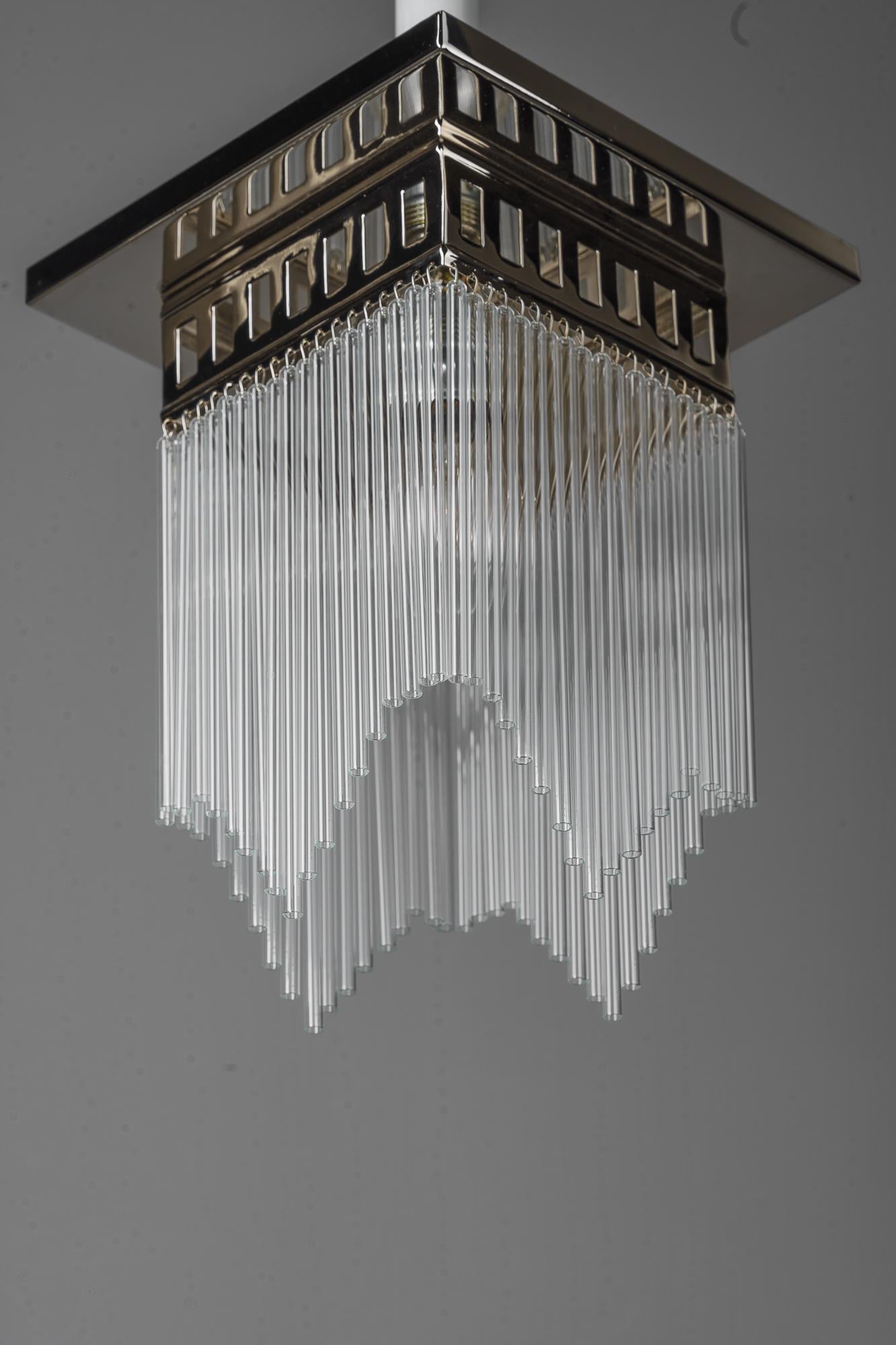 Austrian Reproduction of a nickeel - plated art deco ceiling lamp with glass sticks  For Sale