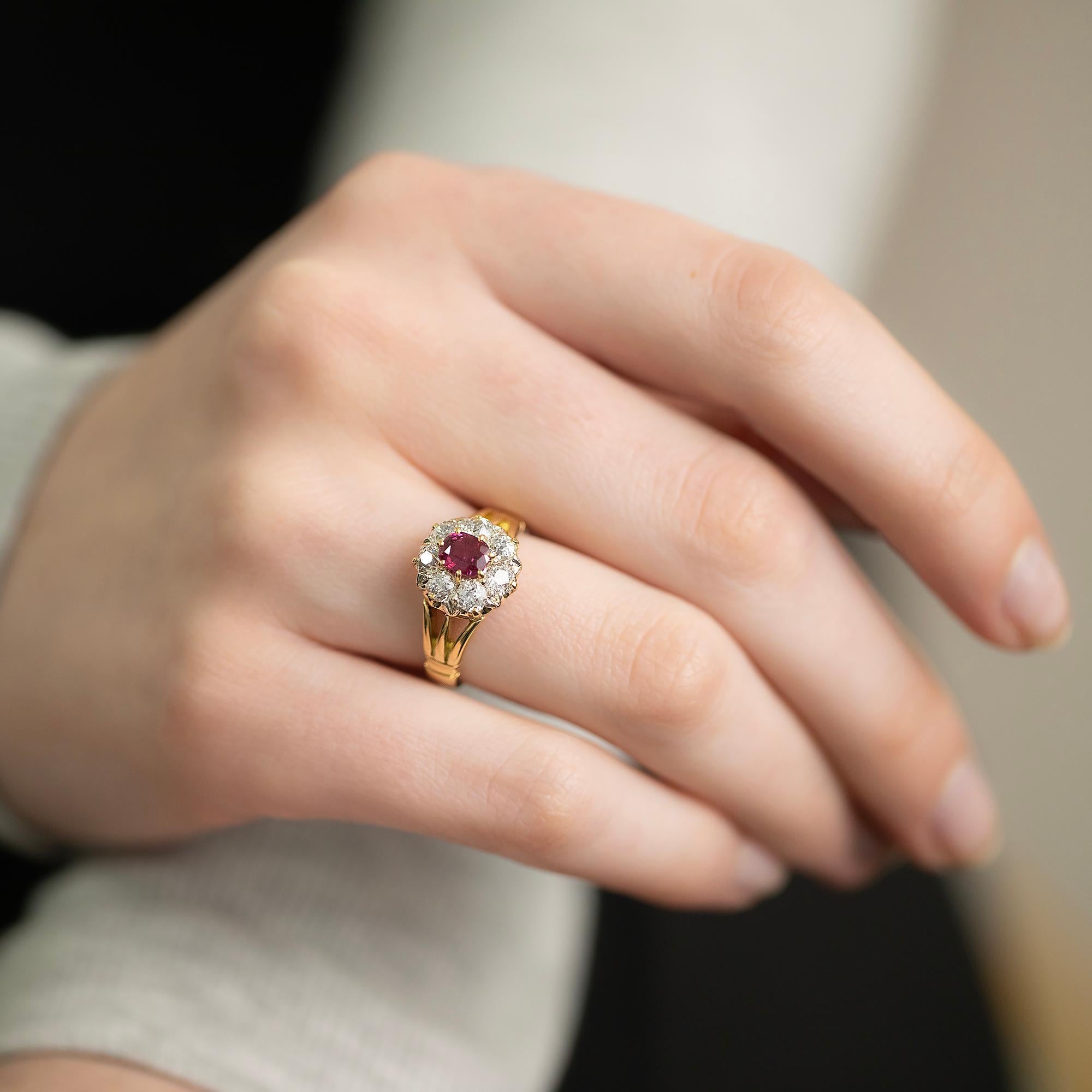 An Edwardian style reproduction ruby and diamond scalloped cluster ring with split shoulders. Featuring an oval ruby surrounded by early =European diamonds.

Gemstones: One oval cut natural ruby, good mid-red material, 5.50mm x 4.44mm x 2.92mm,