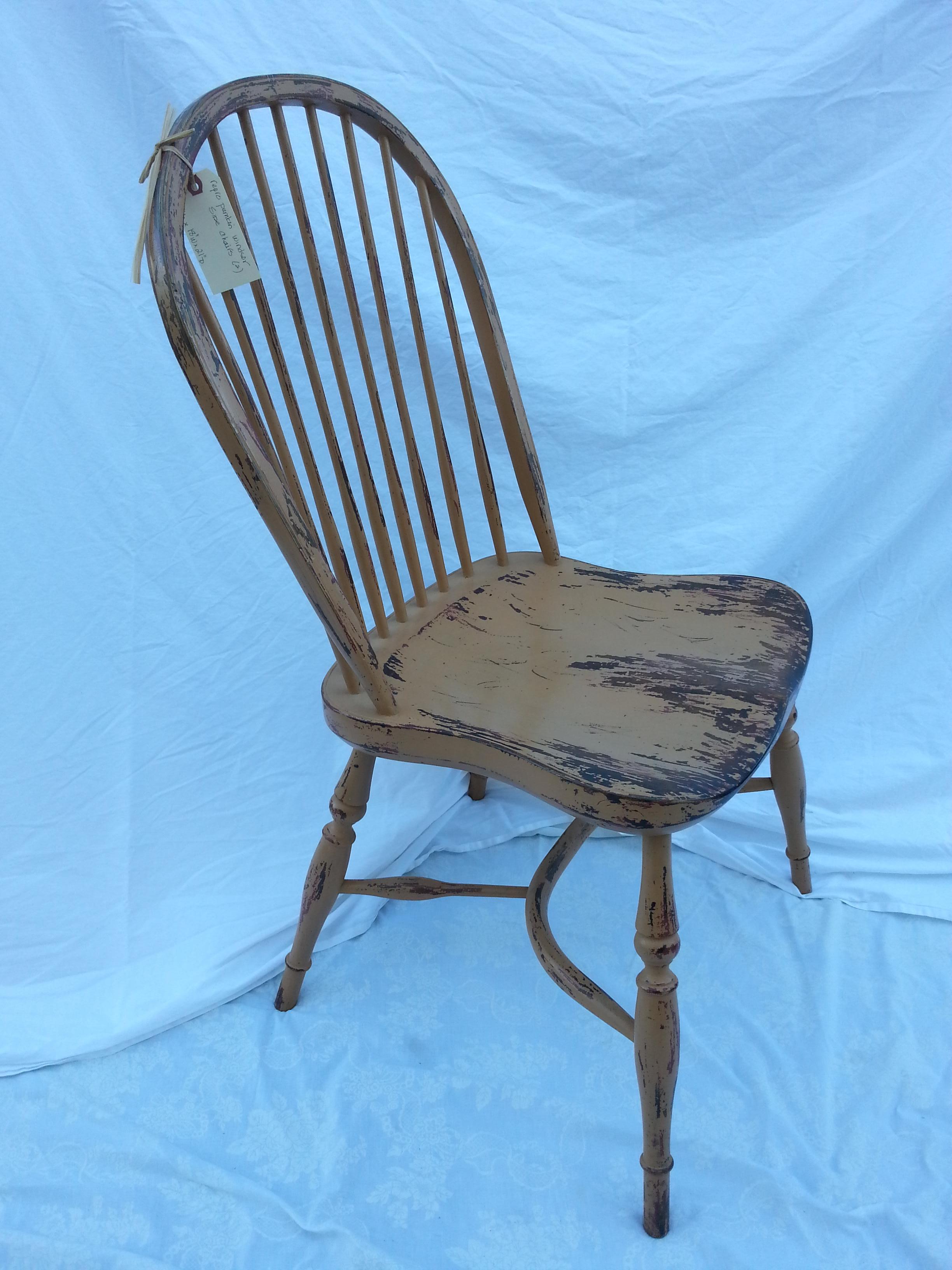 Reproduction spindle back pumpkin color side chair.