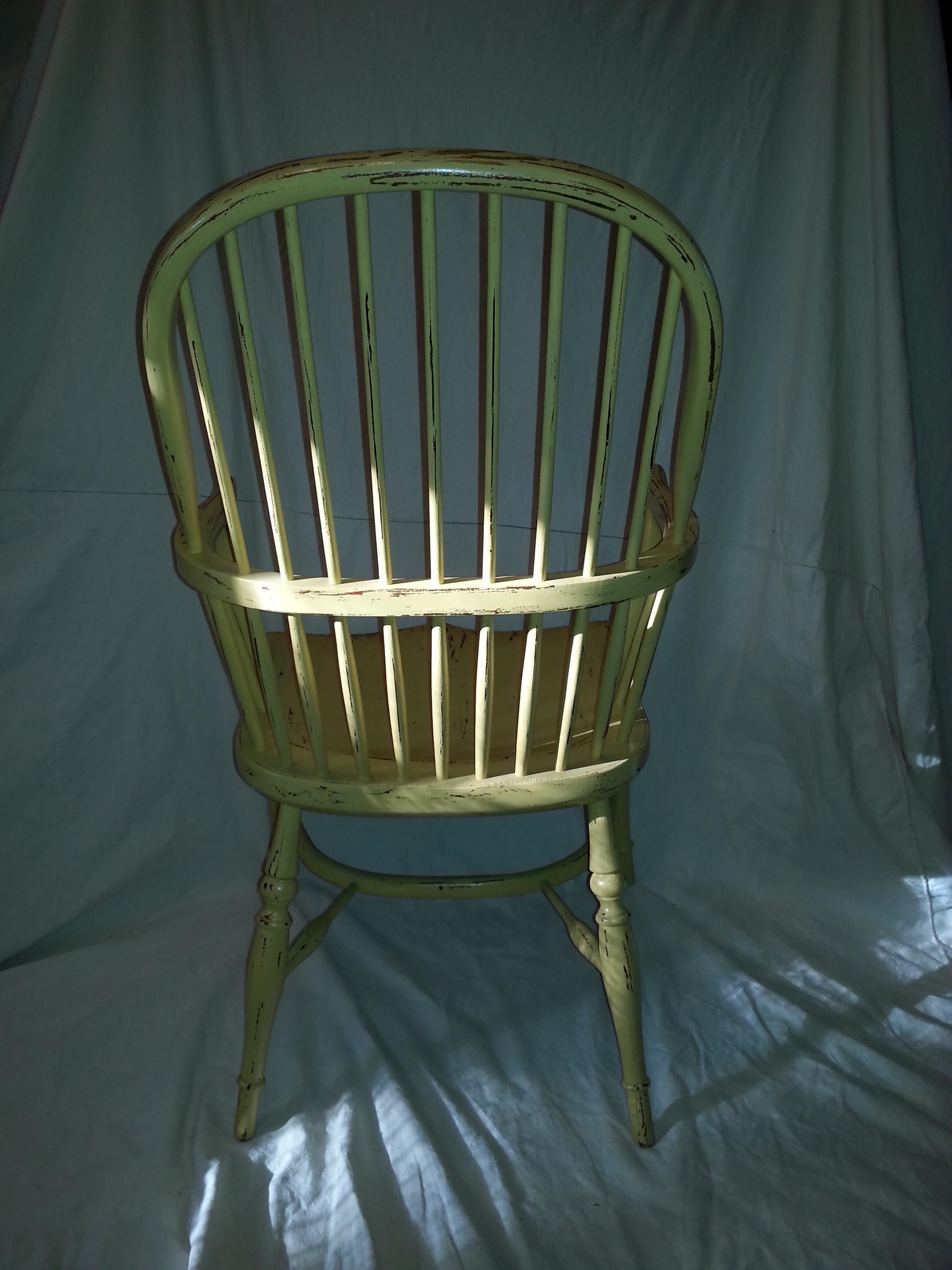 Reproduction Spindle back yellow armchair.