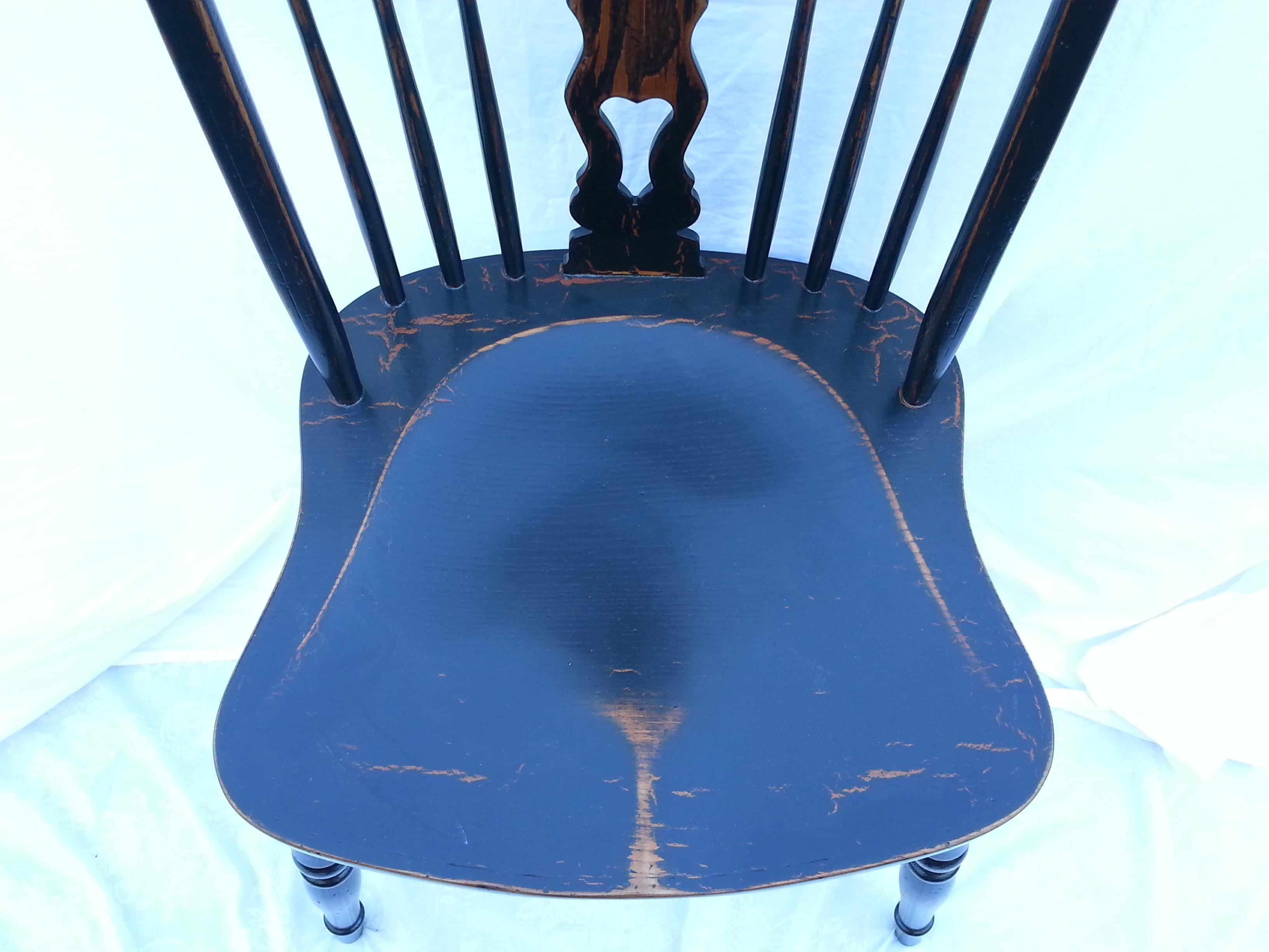 Reproduction splatback armless black crackle chair.