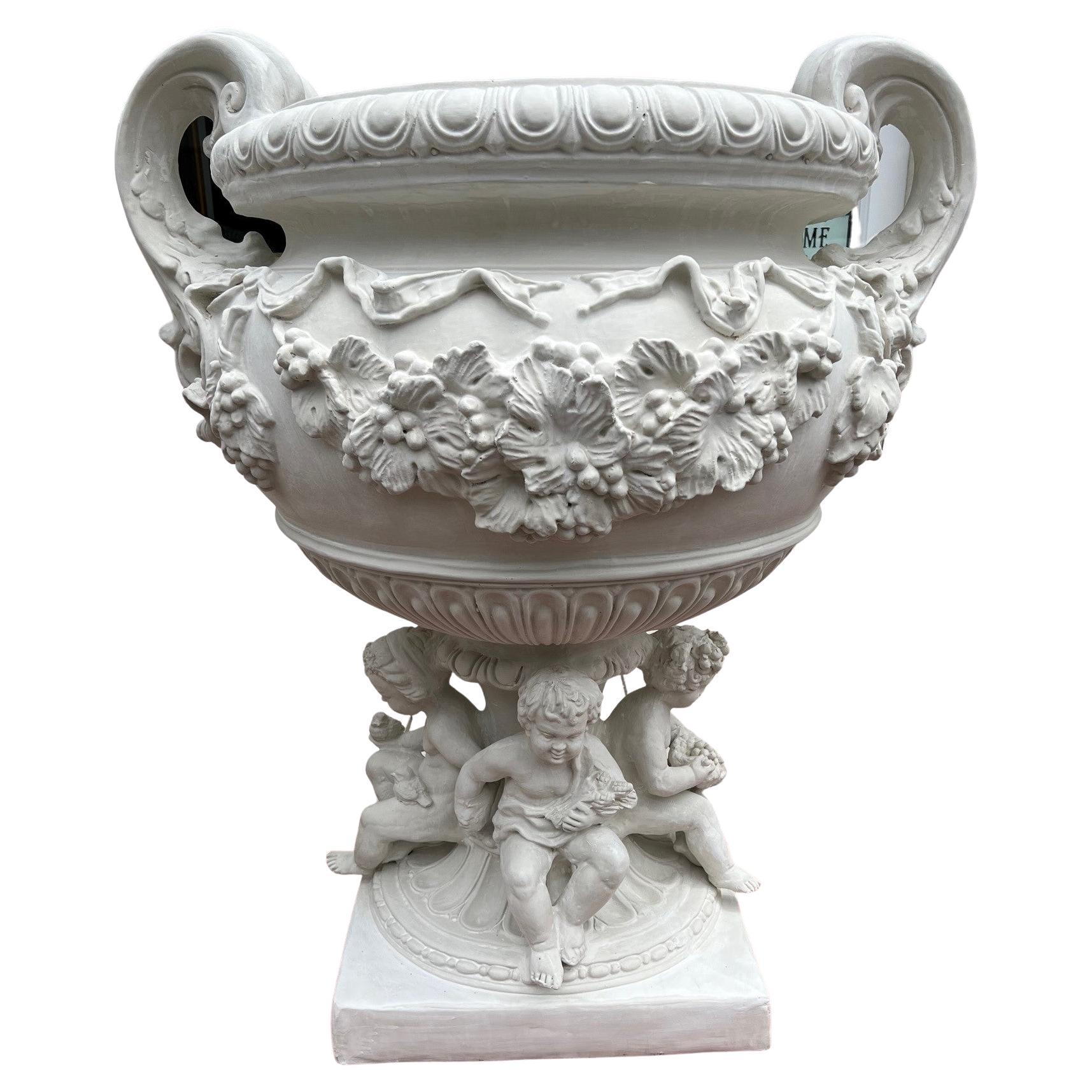 Reproduction White Fiberglass Urn with Large Handles Grape Vines and Cherubs   For Sale