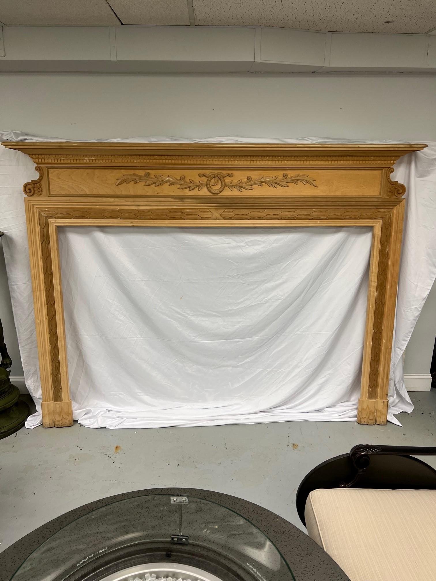 Beautiful reproduction wood fireplace mantel with very nice carvings from a manufacture who closed down years ago in the Brooklyn NY. I believe the wood to be cherry and was made in the Brooklyn facility. The fireplace mantel is unfinished never