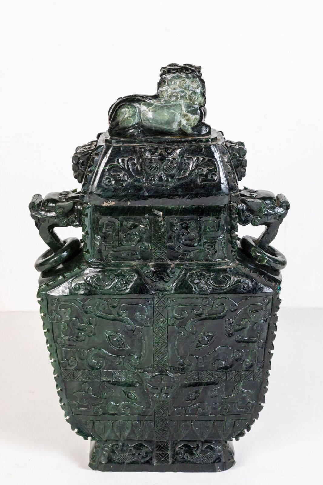 Elaborately carved, richly colored, Chinese, spinach jade urn with Foo dog lid and two-sided, top-to-bottom bas relief, foliate and geometric embellishments.