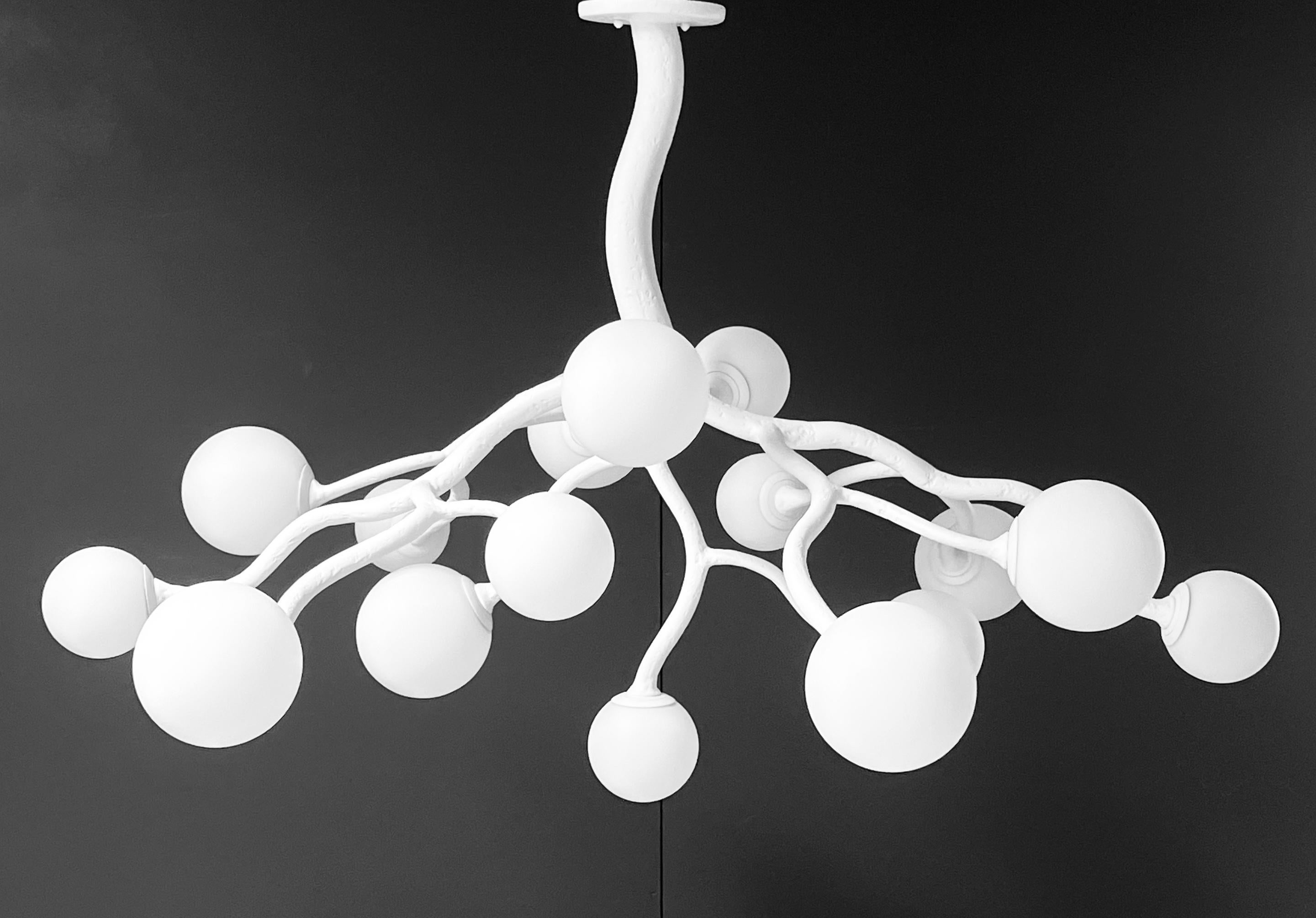 Dive into the elegance of the Republique Chandelier, an exquisite piece that embodies Parisian chic with a contemporary twist. This organic branch shaped chandelier boasts 16 radiant lights, each enclosed by an opaline glass diffusers that cast a