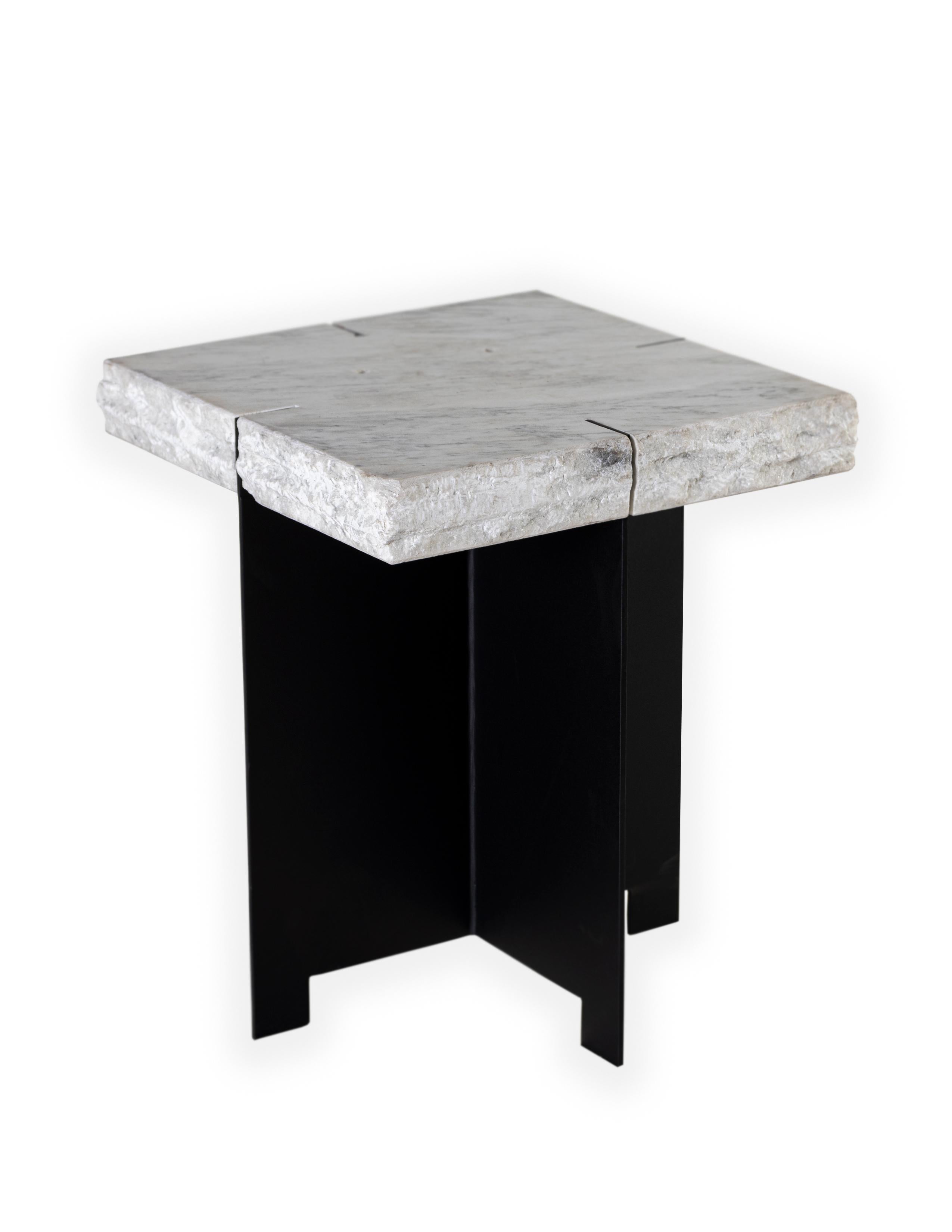 A side table comprised of a repurposed Carrara marble slab that rests on top of a blackened steel mount base.

This piece is suitable for outdoor use. 

A part of the Le Monde collection exclusive to Brendan Bass.