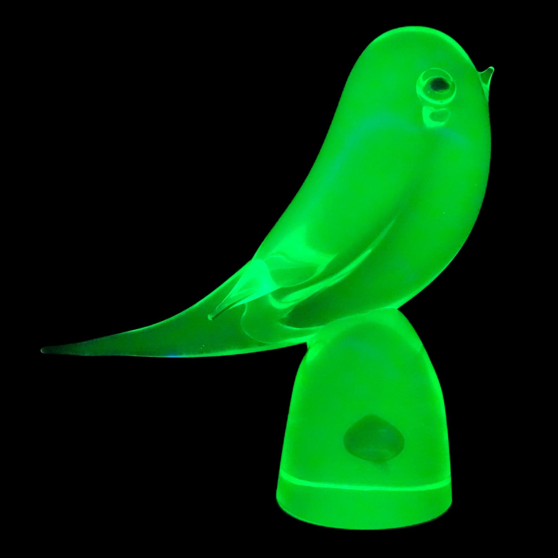 Beautiful and very cute, vintage Murano hand blown Sommerso glowing yellow green and blue Italian art glass bird figurine. Documented to the Cenedese company. Created with Uranium glass, which glows neon green under a black light. It has blue eyes,
