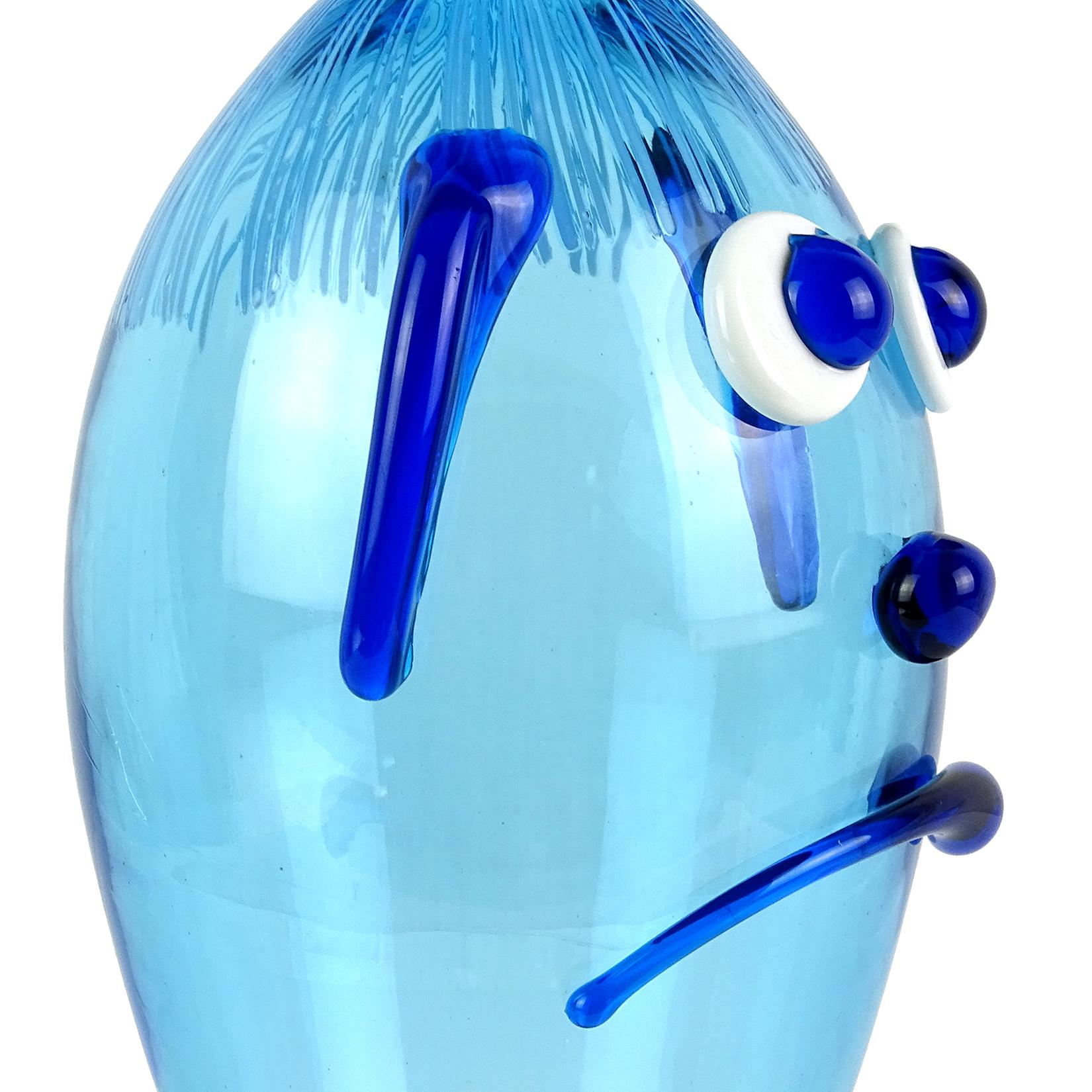Cute and unusual Murano hand blown Italian art glass decanter, clown face in blue. Documented to the Fratelli Toso Company. The piece has applied ears, big eyes, a frown and threads of light blue glass for the hair. Measures: 11