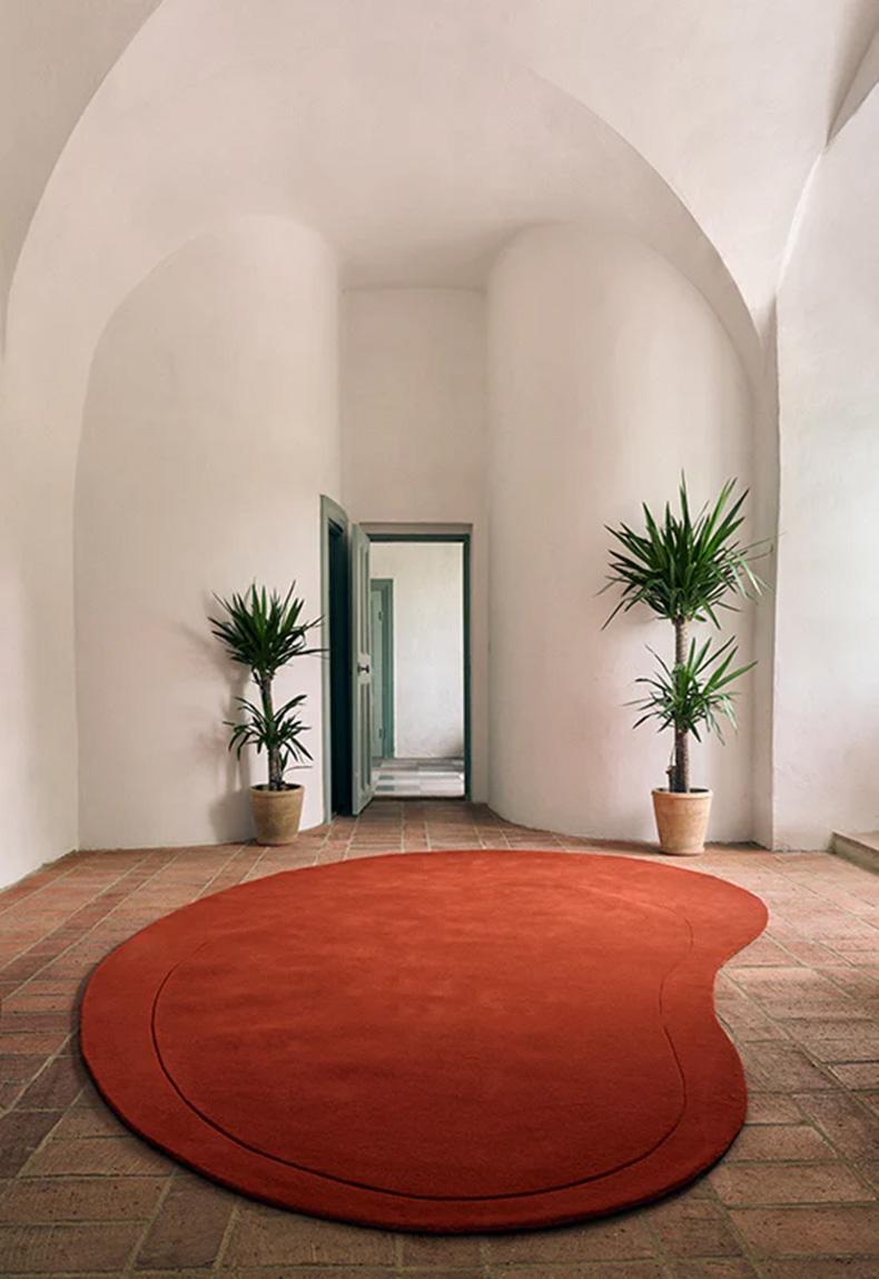 Residue Tomato Wool Rug is a unique, big rug with one organic stripe that makes a difference in the height. With its structured wool and the high and low cut, Residue can be an art piece to the room but at the same time, fulfill its functions as a