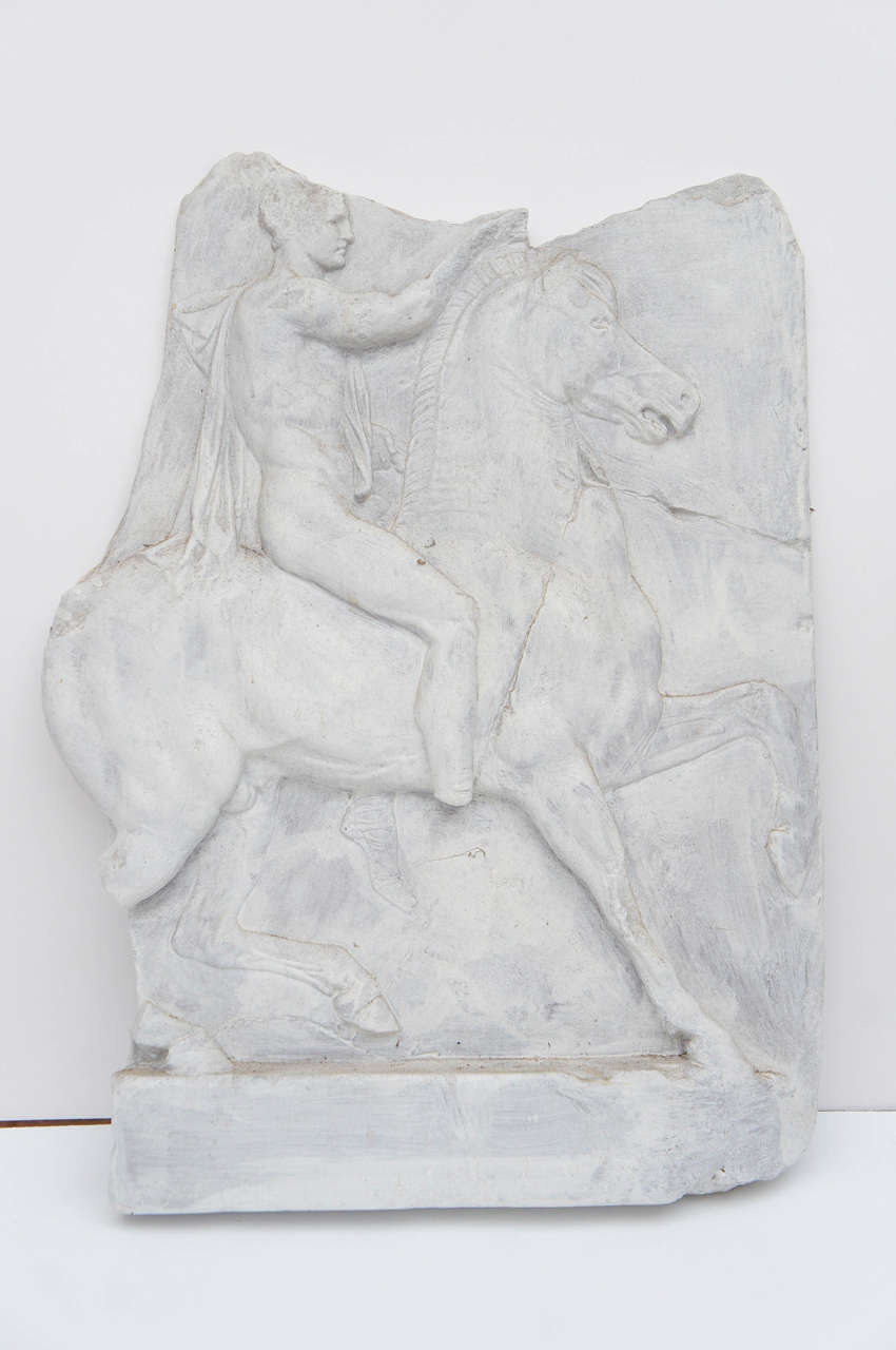 Resin and white painted relief of Ancient Roman rider on horseback.