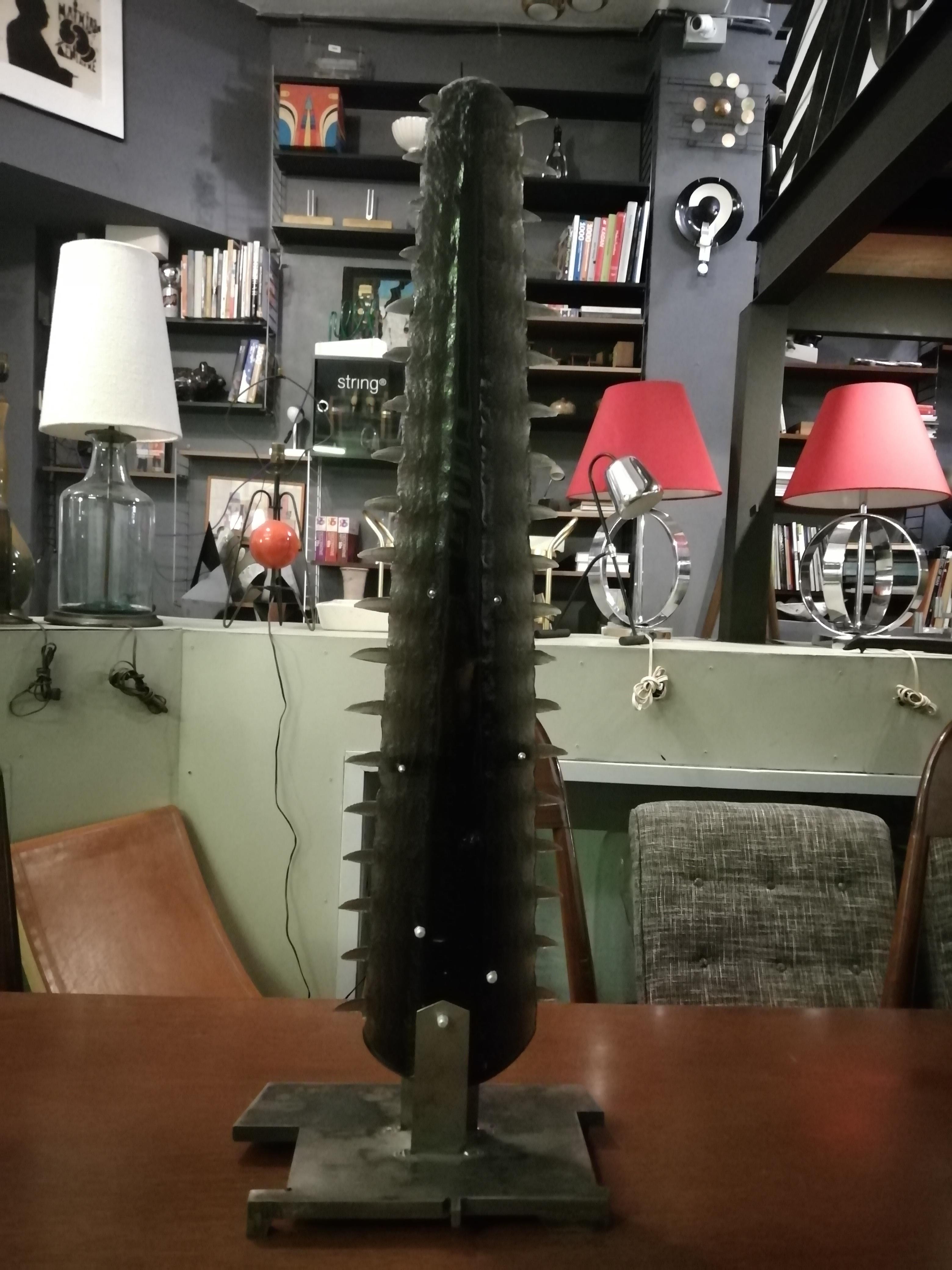 An unusual dark resin sculpture in the shape of a sawfish rostrum by Mexican artist Viktor Martínez. The piece is mounted on an Industrial style steel base.