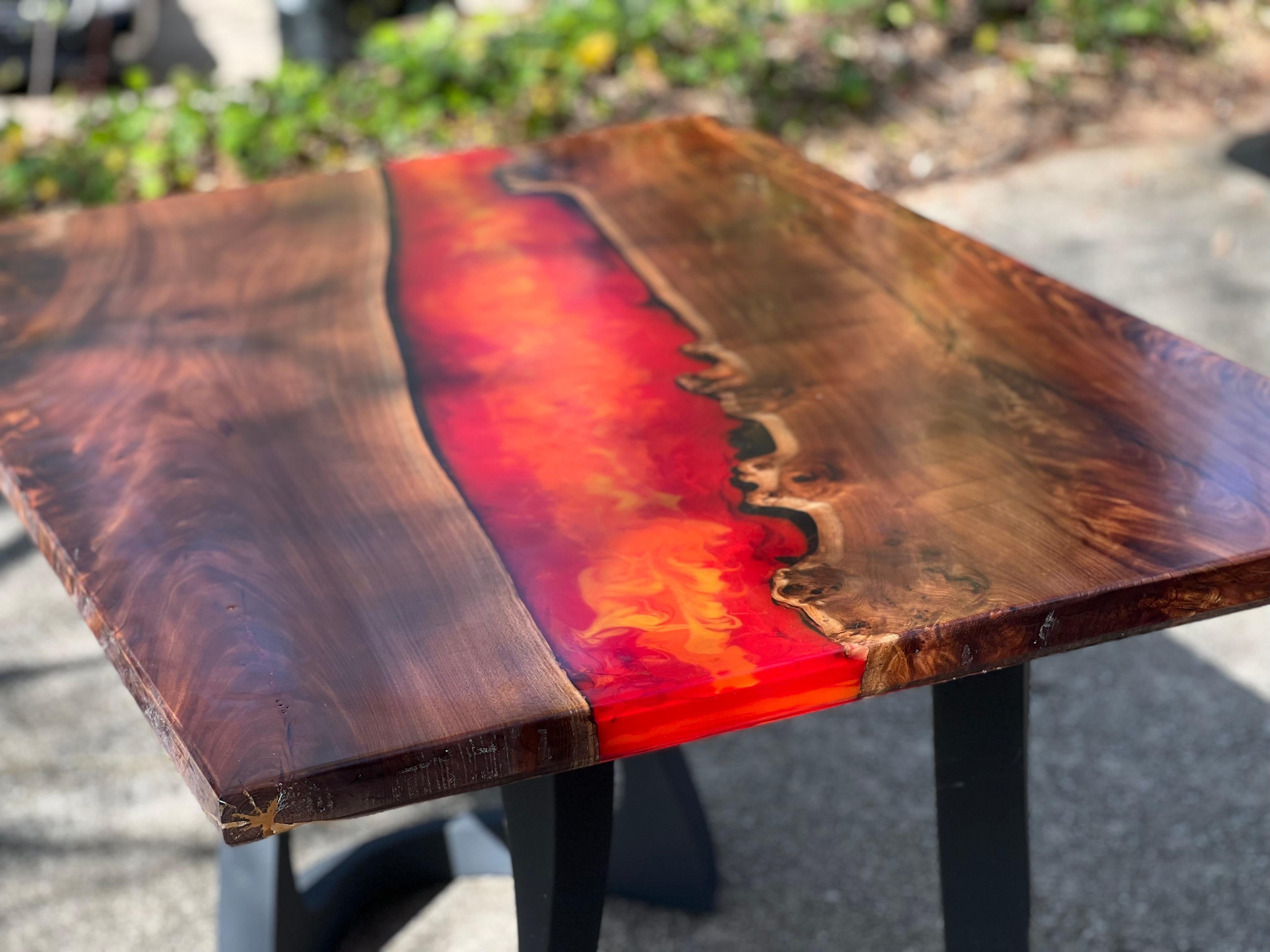 
Immerse yourself in the natural world with our custom dining table, a masterpiece forged from the marriage of live-edge wood and mesmerizing lava epoxy resin. This one-of-a-kind creation encapsulates the raw beauty of nature and the modern artistry