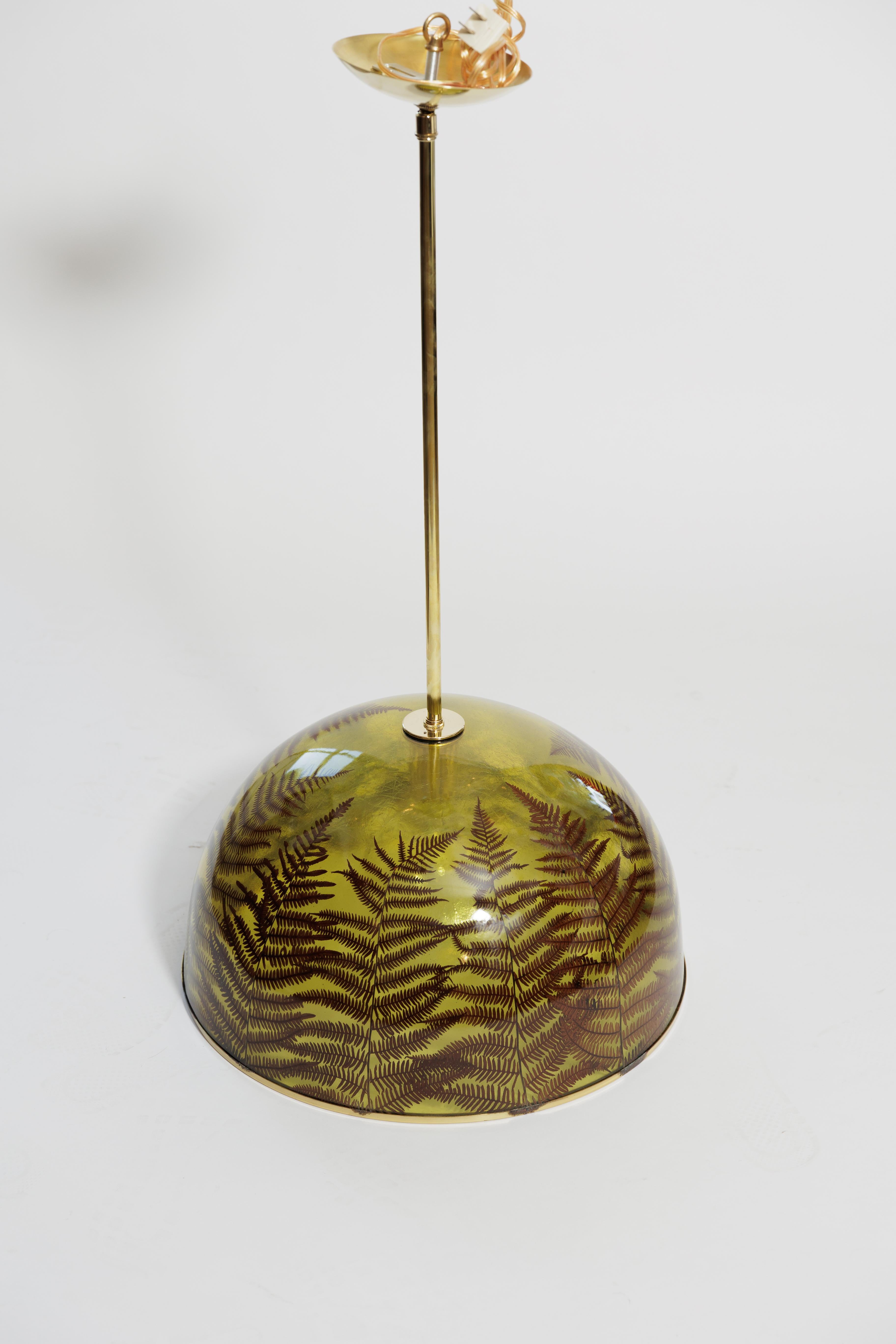 Unusual resing pendant encasing natural elements (ferns) with brass details.
Two are available.