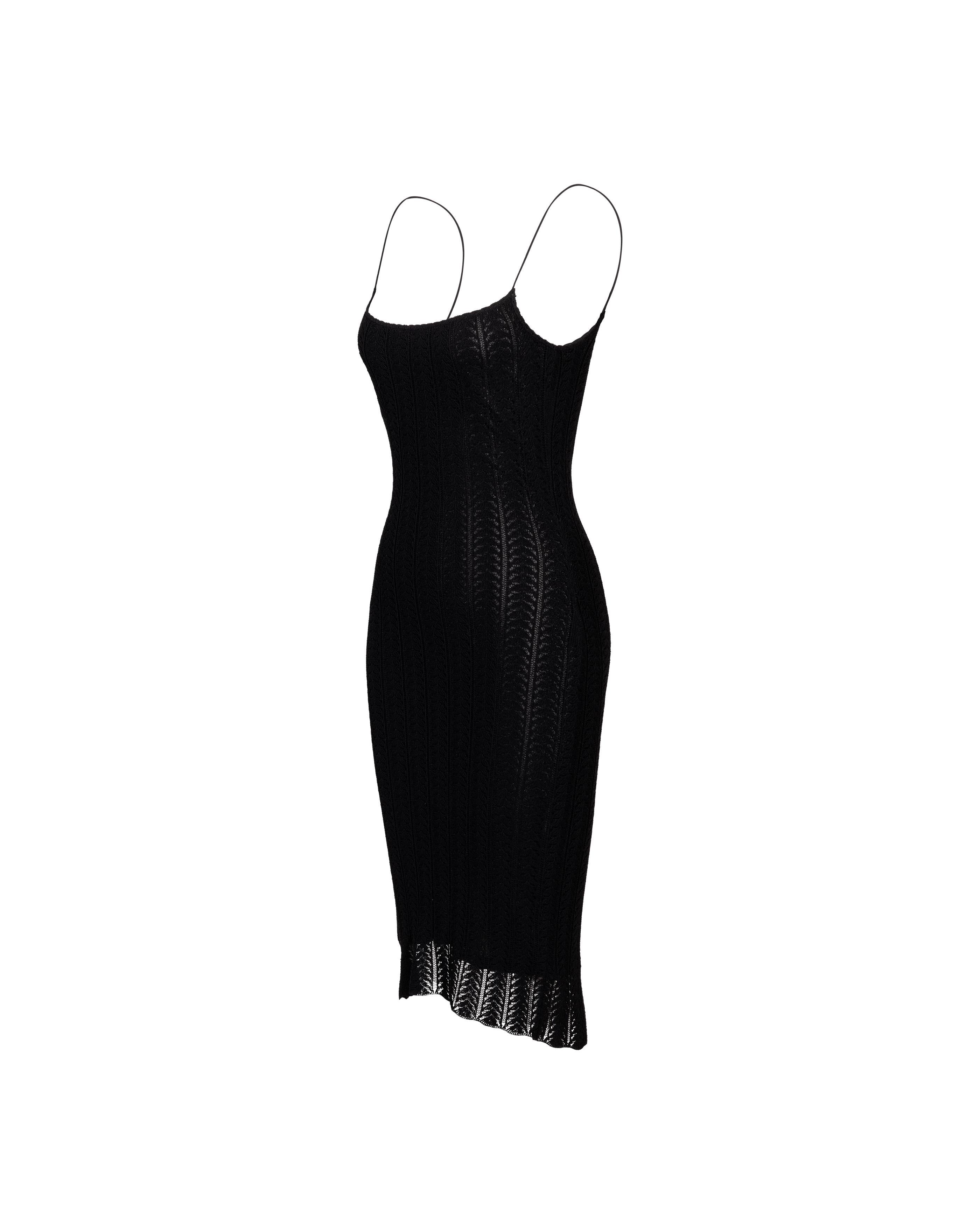 Resort 2000 John Galliano black openwork knit knee-length slip dress. Sleeveless spaghetti strap bodycon dress; semi-sheer open perforated geometric vertical stripe knit mesh. Fully lined with black lining that ends approximately 2