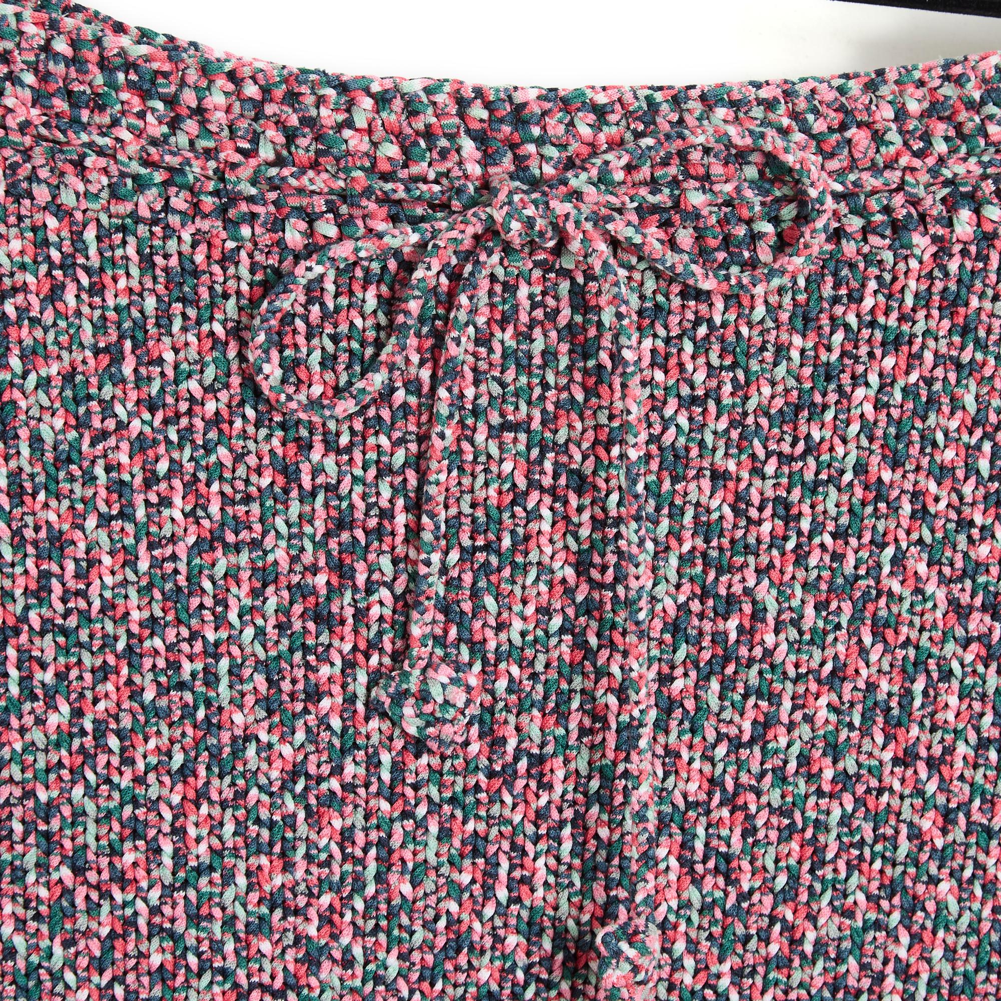 Short Chanel skirt from the Cruise 2012 collection in cotton knit in shades of pink, green and ecru, low waist held in place by a drawstring, bottom of the skirt decorated with a croquet, unlined, Chanel logo in silver metal and gray enamel stitched