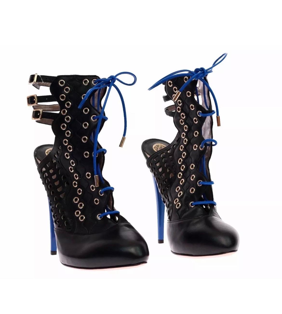 VERSACE
Resort 2012 look # 13 
Perforated leather ankle boots
Three straps
Blue laces and heel 
Leather sole
Gold-plated hardware 
IT Size 39 - US 9
Heel 5 1/4
