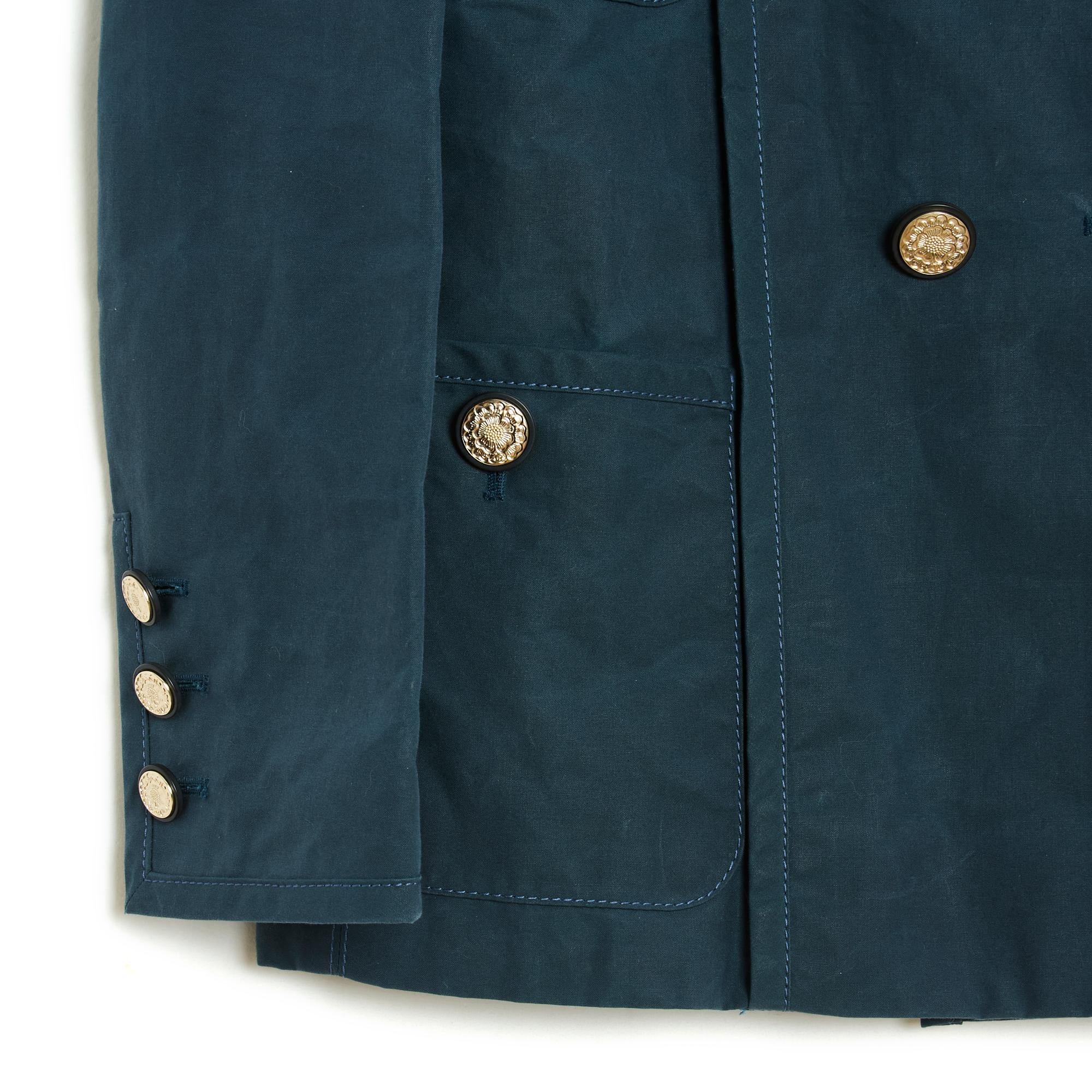 Chanel jacket from the Cruise 2020 collection in thick blue cotton canvas, between a peacoat and a blazer, straight cut, wide notched collar closed with double-breasted buttons, 4 buttoned patch pockets, padded shoulder inserts, long sleeves closed