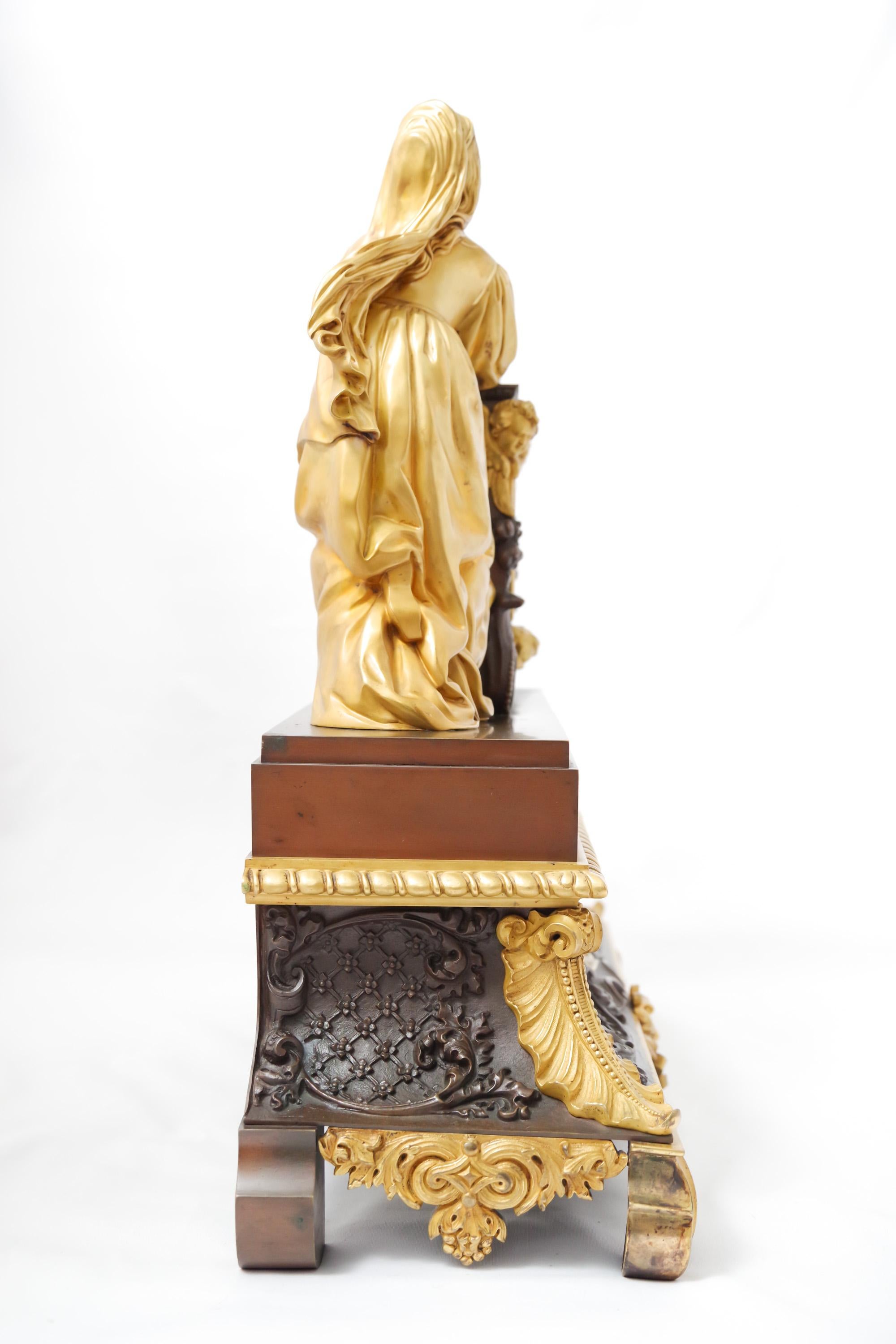 A French patinated and fire-gilt clock depicting a woman in prayer, Restauration Era, 1815-1830. The dial is silvered-bronze. The silk-thread mechanism is in good working condition with key and pendulum.