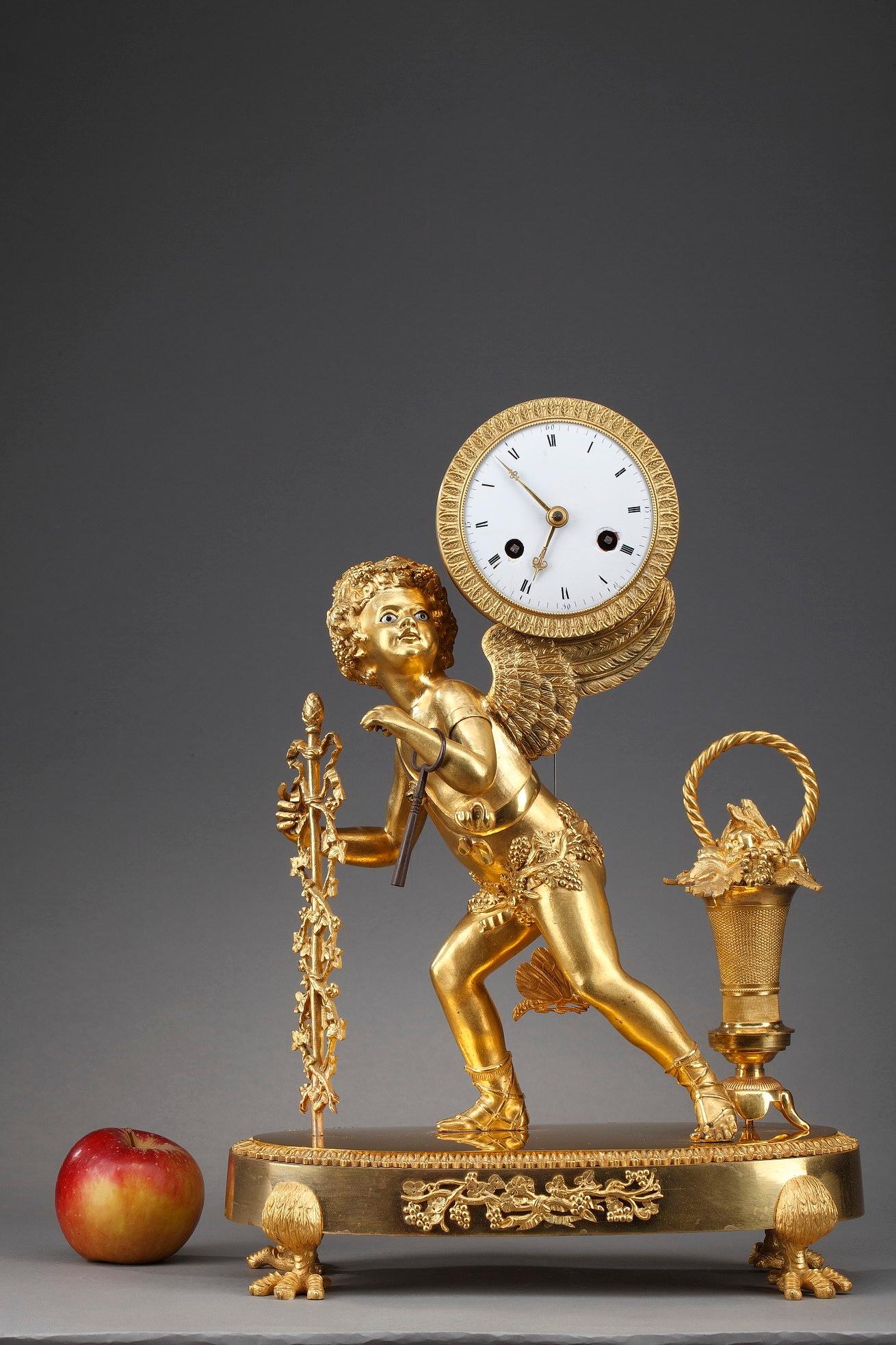 Restauration clock with peddler crafted of gilt bronze featuring a winged Cupid holding a thyrse and carrying on his back the dial. His enameled eyes contrast with the gold patina of his skin. The clocks depicting small trades such as sailor,