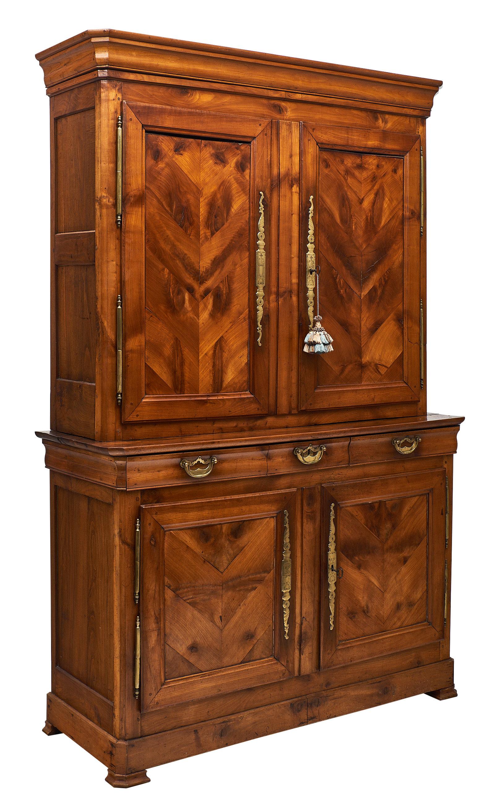 French Restauration style double corps buffet made of solid walnut and featuring engraved bronze hardware. We love the beautiful warm wood and classic antique details of this impressive piece. The doors have a working lock and key, and open to