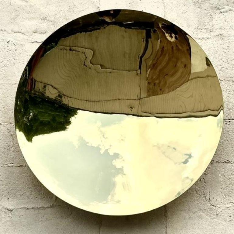 Add a touch of Boho elegance with this RH convex mirror. Framed in polished brass metal, its unique shape and vintage vibe make it a striking accent piece, perfect for enhancing any room's light and depth.