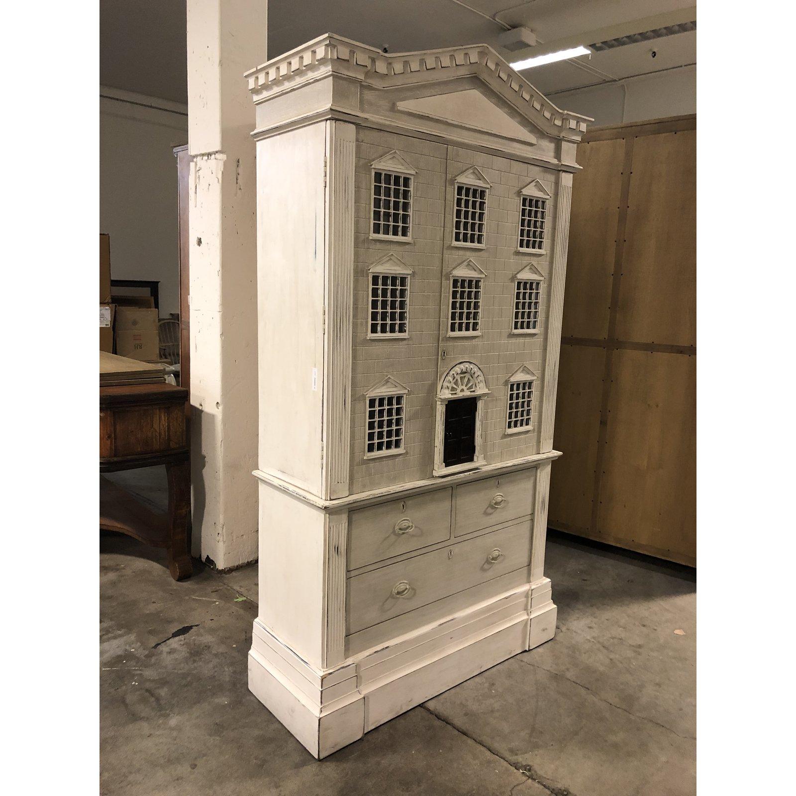 A doll house cabinet by Restoration Hardware. Inspired by architectural grandeur of a neoclassical home. A multipurpose storage cabinet, giving it a playful edge that lends charm to any room. Designed to look like an antique dollhouse but function