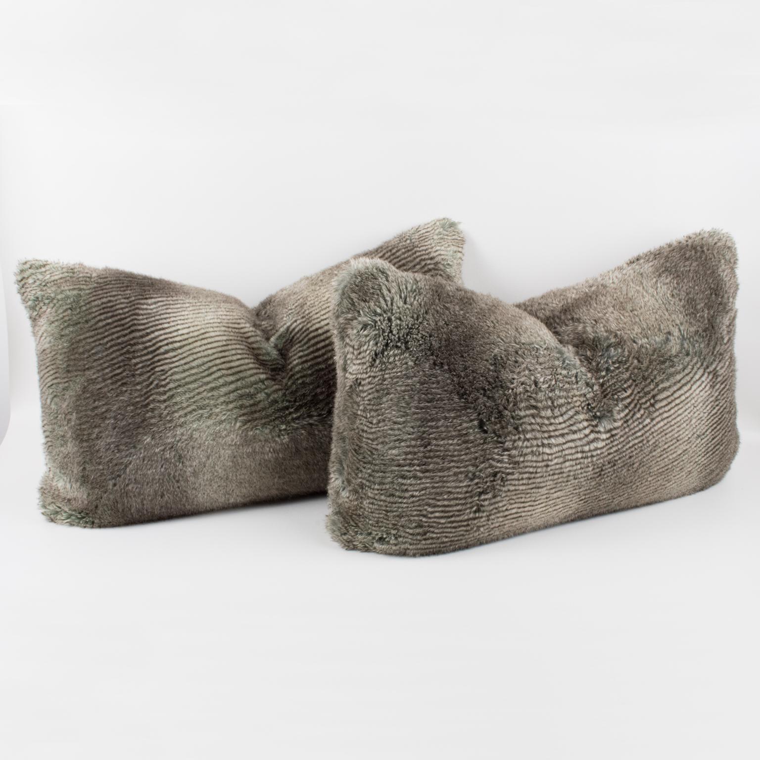 Lovely set of throw pillows by Restoration Hardware. These lumbar pillows are covered with faux fur material imitating wolf fur. A zipper encloses an inner feather pillow. An accent for the sofa or armchair with character.
Measurements: 25 in. wide