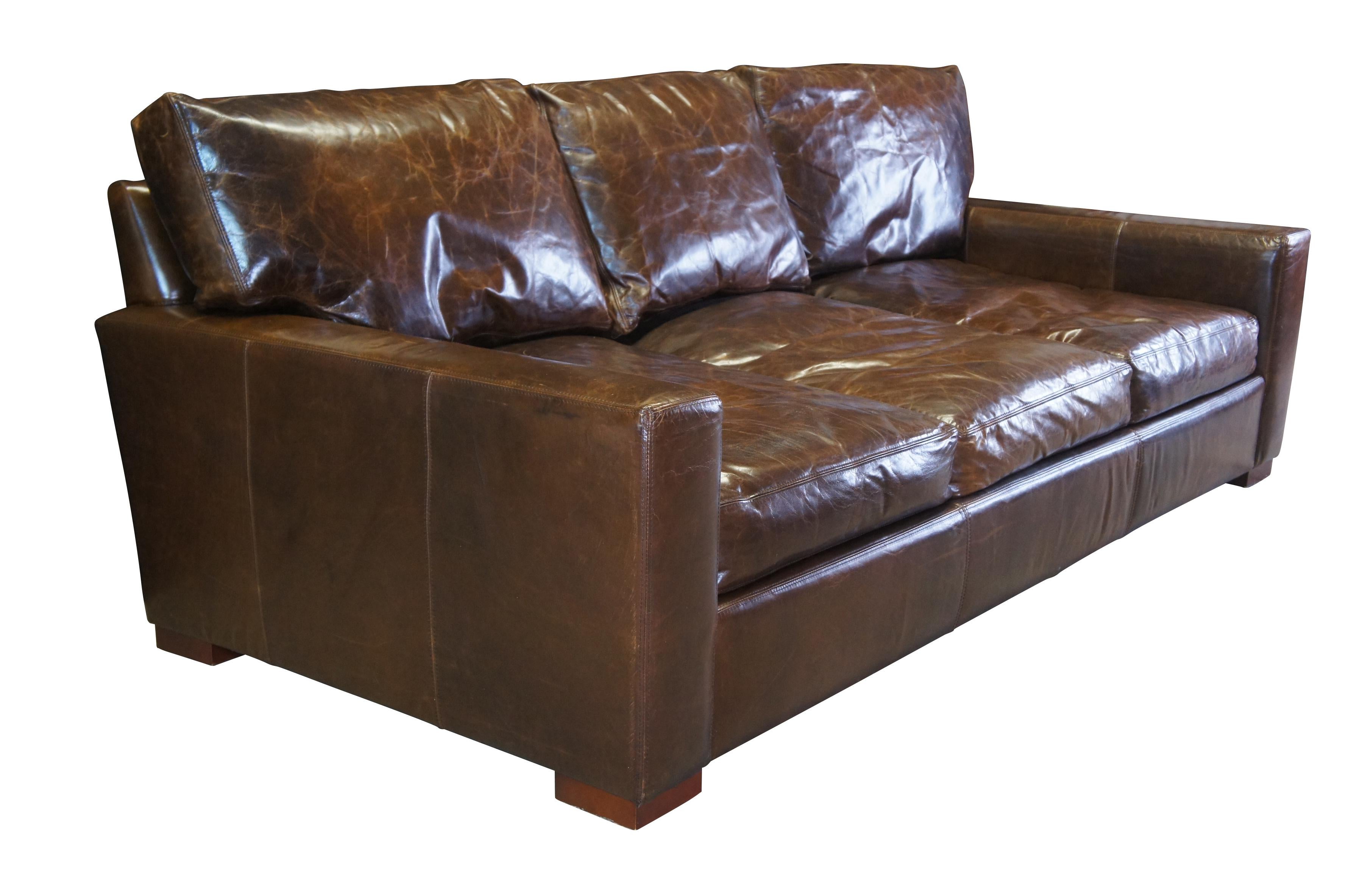 A luxurious 3 Seater sofa by Restoration Hardware. The Maxwell is upholstered in a supple cocoa brown leather for maximum comfort. Cutting a clean lined silhouette with ultra-deep proportions, this sofa features squared, track arms and a modernist,