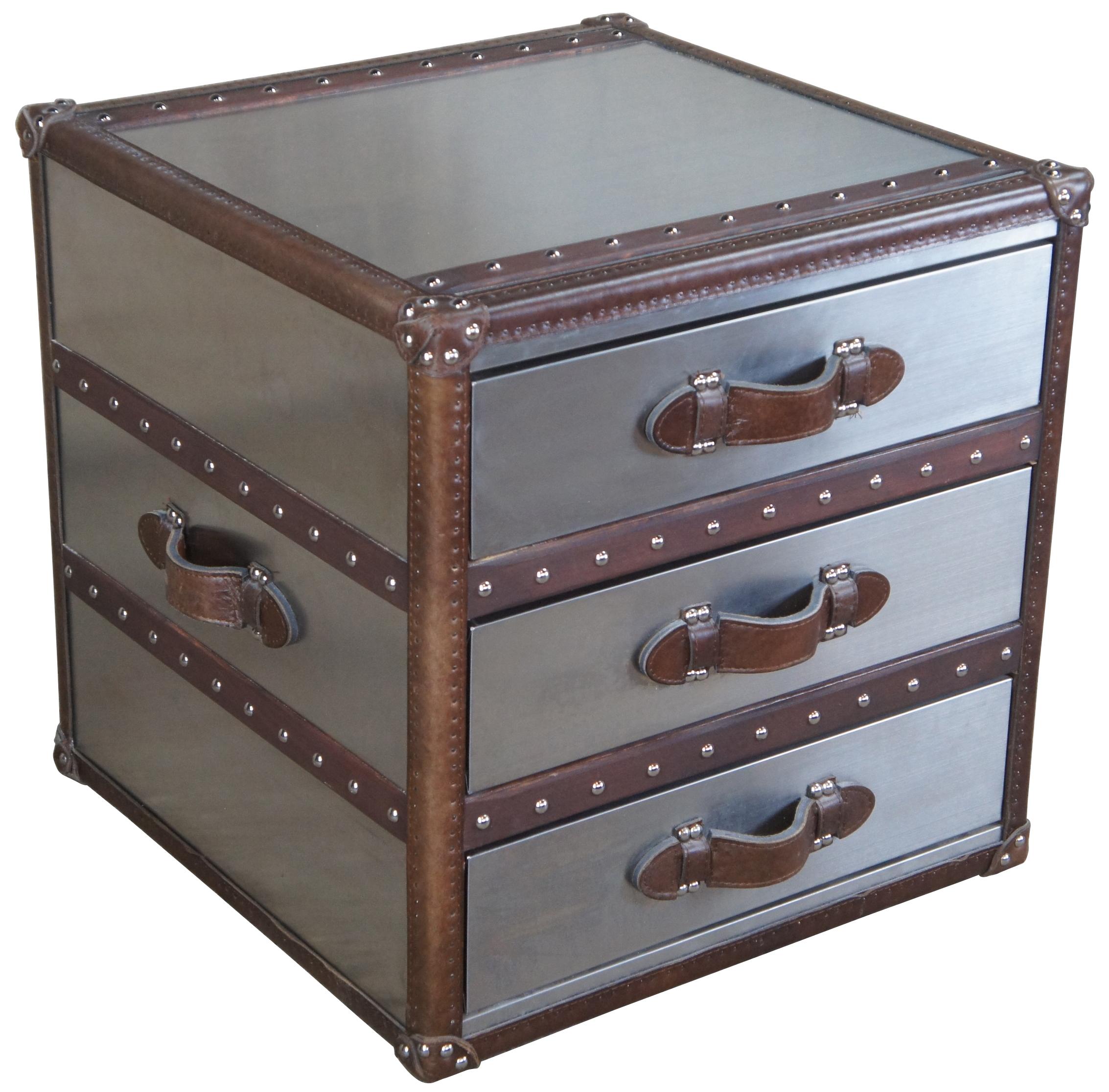 Handmade of brushed steel over a solid wood frame
Accented with up to 3,000 hand-hammered brass nailheads
Features canvas-lined drawers
Leather-bound corner brackets, leather-wrapped handles, oak slats with a tobacco finish and cast-metal