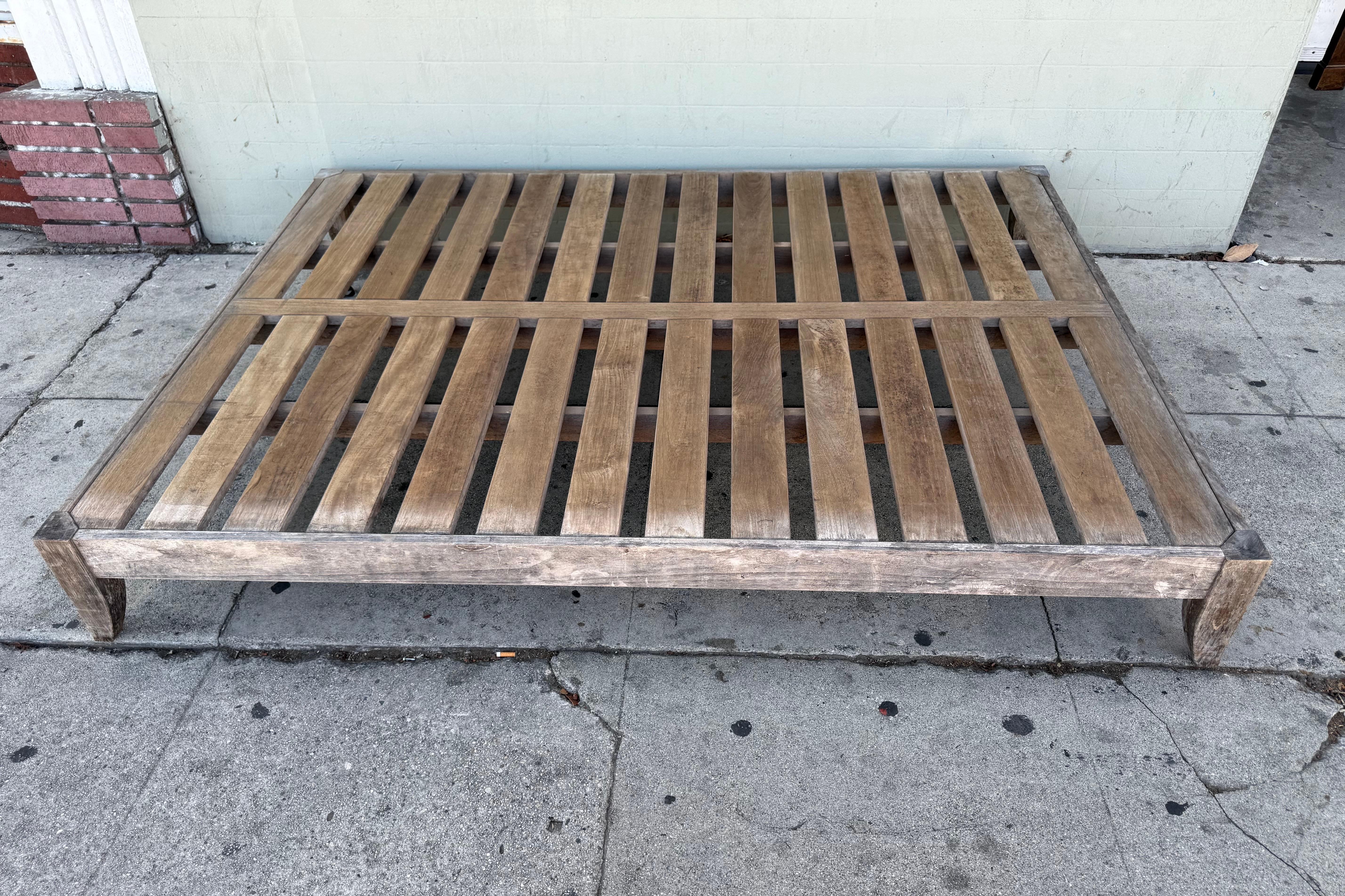 Beautifully chaise lounge design by Restoration Hardware. This wonderful piece is crafted from solid teak wood and features a sturdy slatted design with a natural weathered patina that showcases its outdoor character. The frame is strong, stable,