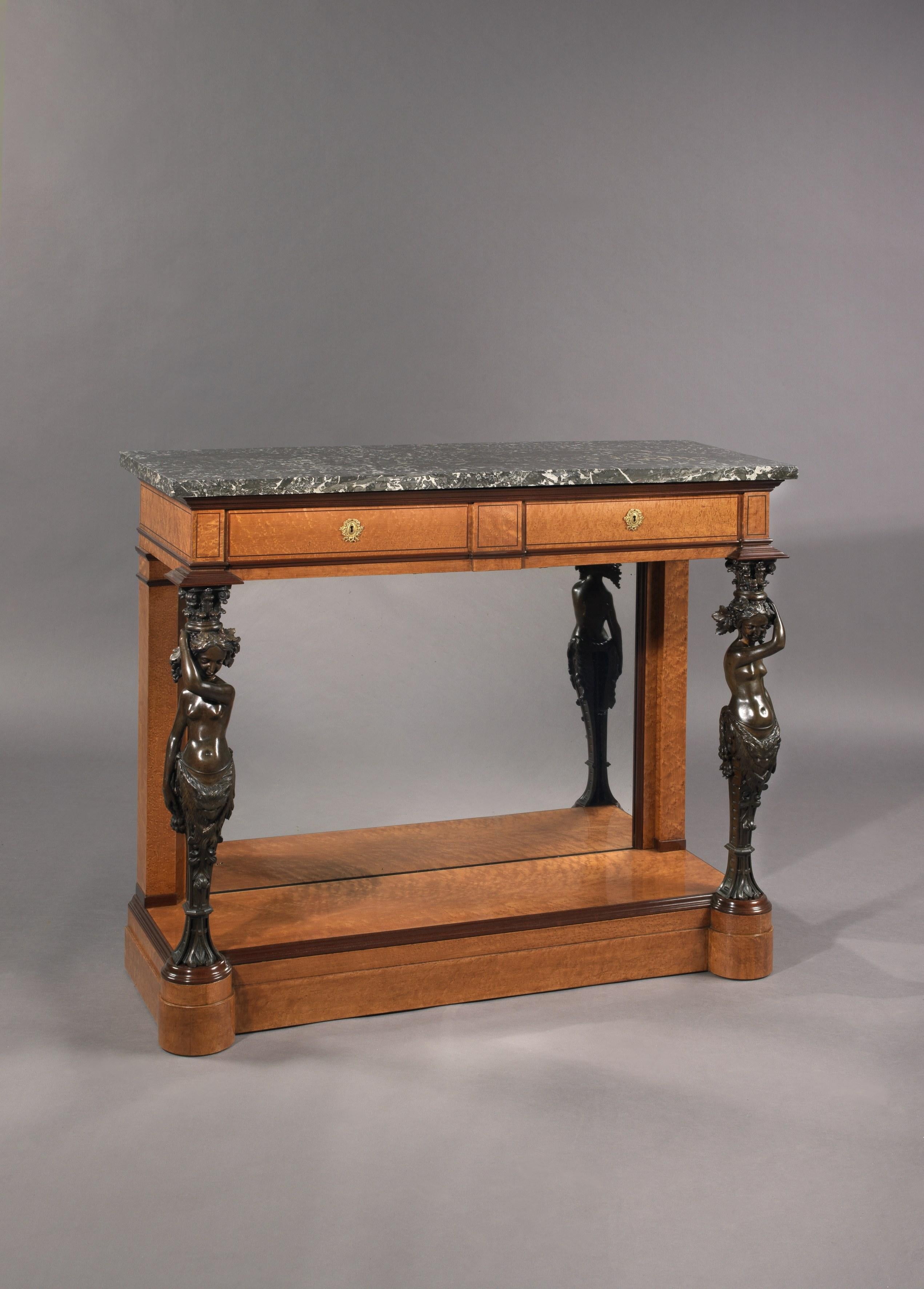 A highly important restoration period maple and Amaranth veneered console table with patinated bronze female term supports, made for King Louis-Philippe by Jean-Christophe Fischer.

French, circa 1830. 

This rare console table has a rectangular