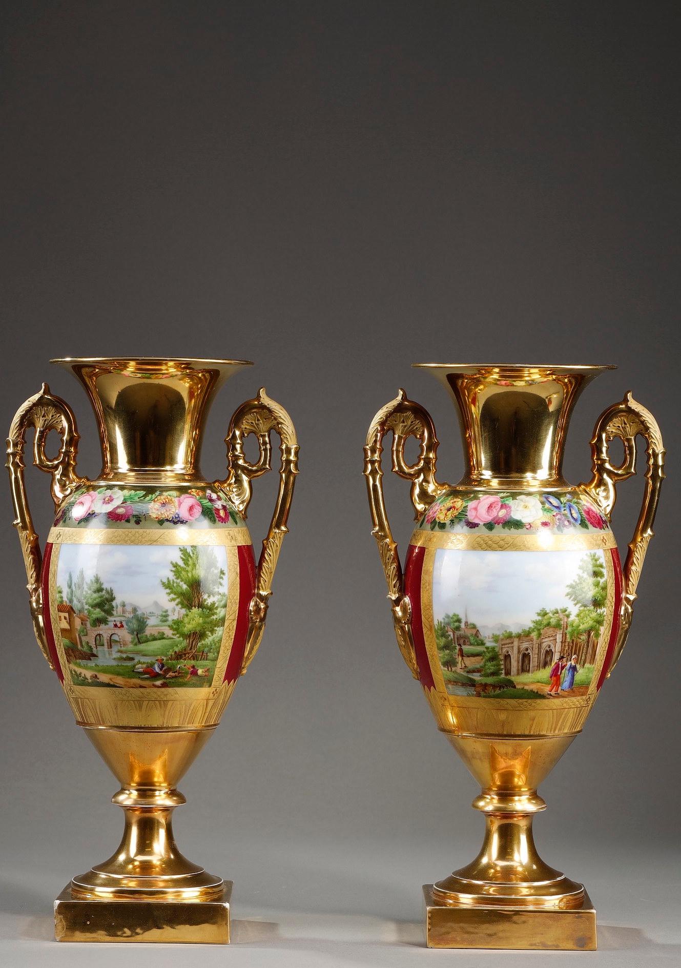 Antique style pair of vases in the form of amphorae in polychromed porcelain from Paris. On a gold and burgundy background, stands out a medallion with a white background with fruits on one side and idealized bucolic landscapes in a golden frame on