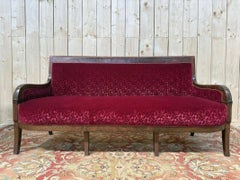 Restoration period settee in mahogany and red velvet