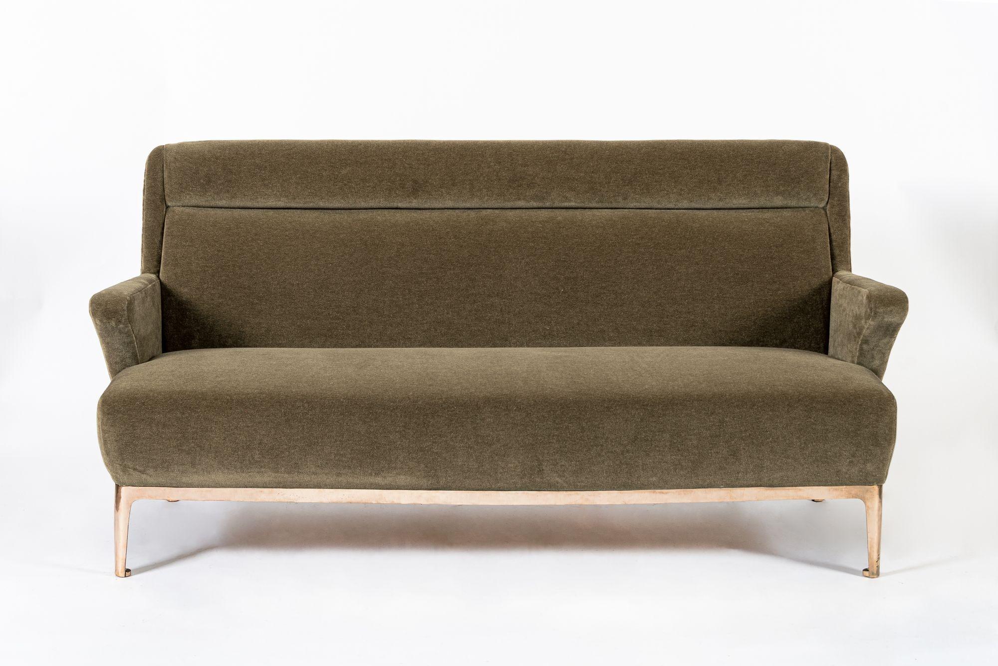 Note: We have additional matching sofa and lounge chair sets undergoing restoration and can offer sofas and chairs in multiples and with custom upholstery options. Please reach out for further details.

This expertly-crafted, elegantly proportioned