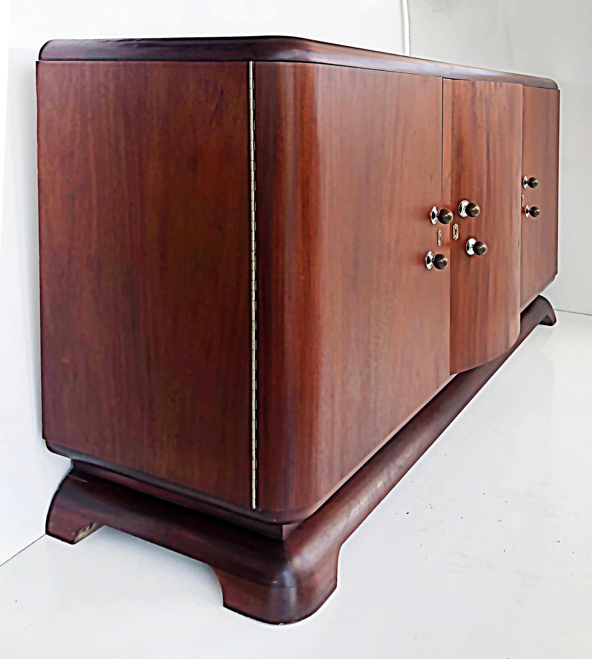 Restored 1940s French Art Deco sideboard

Offered for sale is a French art deco sideboard with three doors that open to reveal fitted drawers in the middle and open shelves on the sides. It should be noted that the shelves are missing and would