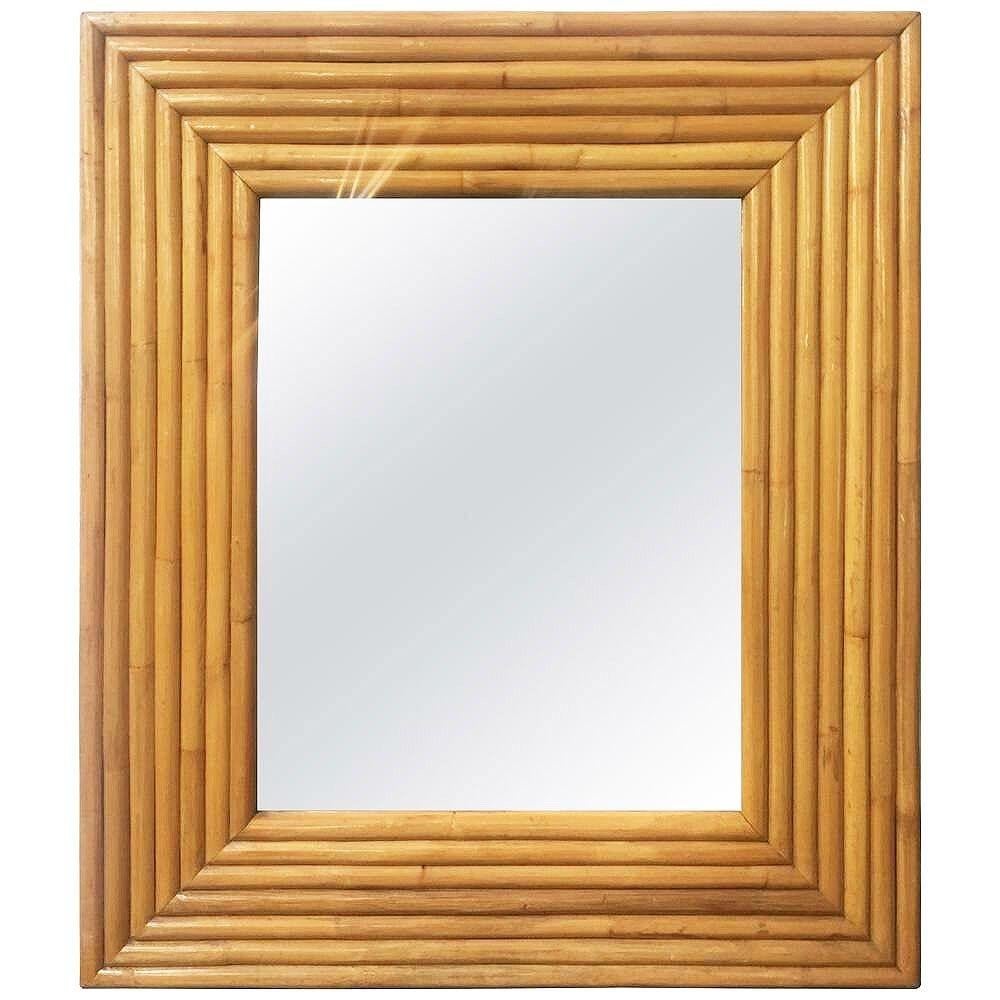 This beautifully restored 1948 new-stock rattan frame is from the unused stock of Tropical Sun Rattan Company of Pasadena. The Mirror features a 7-strand stacked rattan frame with a 28