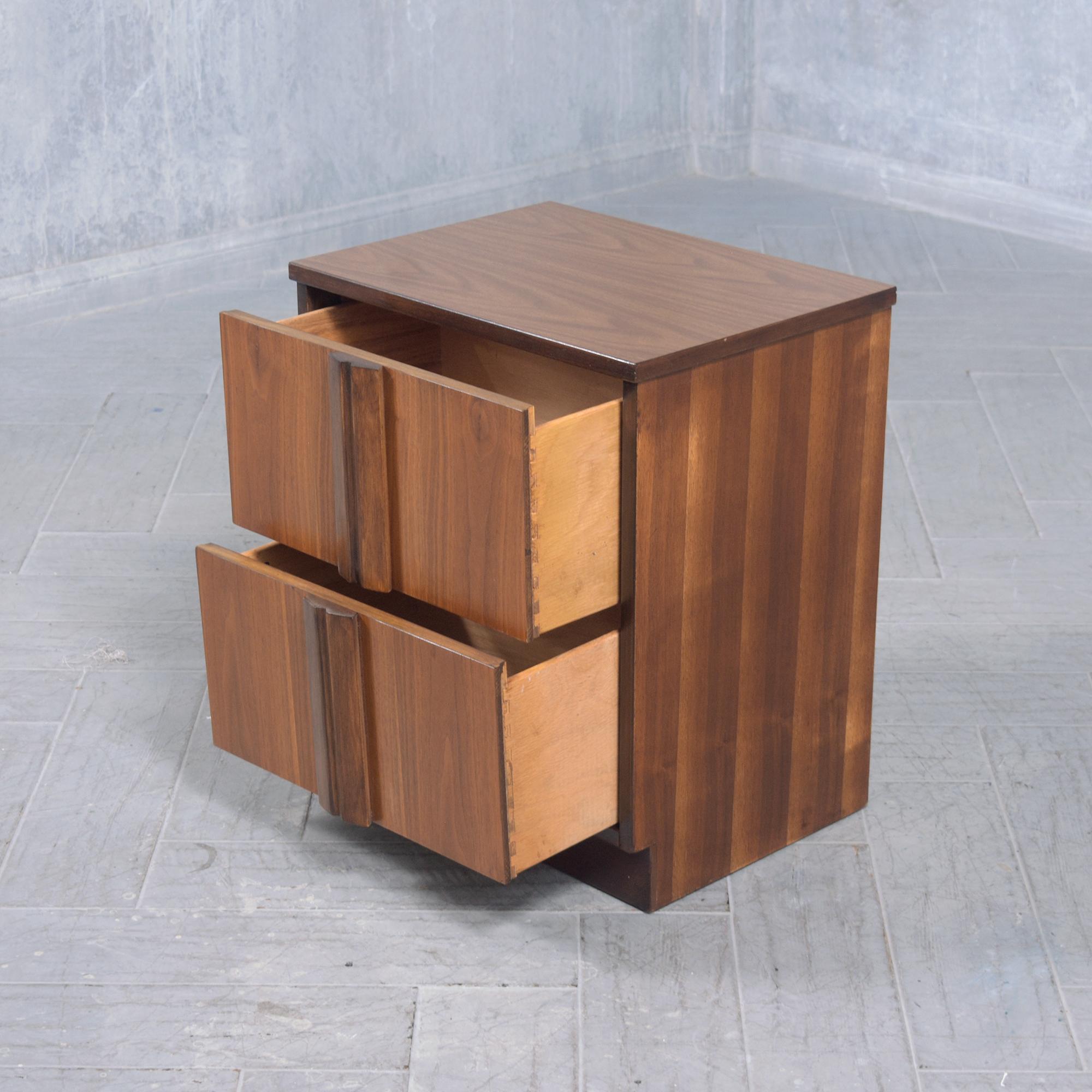 Dive into the mid-century era with this exceptional 1960s nightstand, masterfully crafted from walnut wood. Professionally restored by our in-house team of experts, this single bedside table is in great condition. It boasts a harmonious blend of