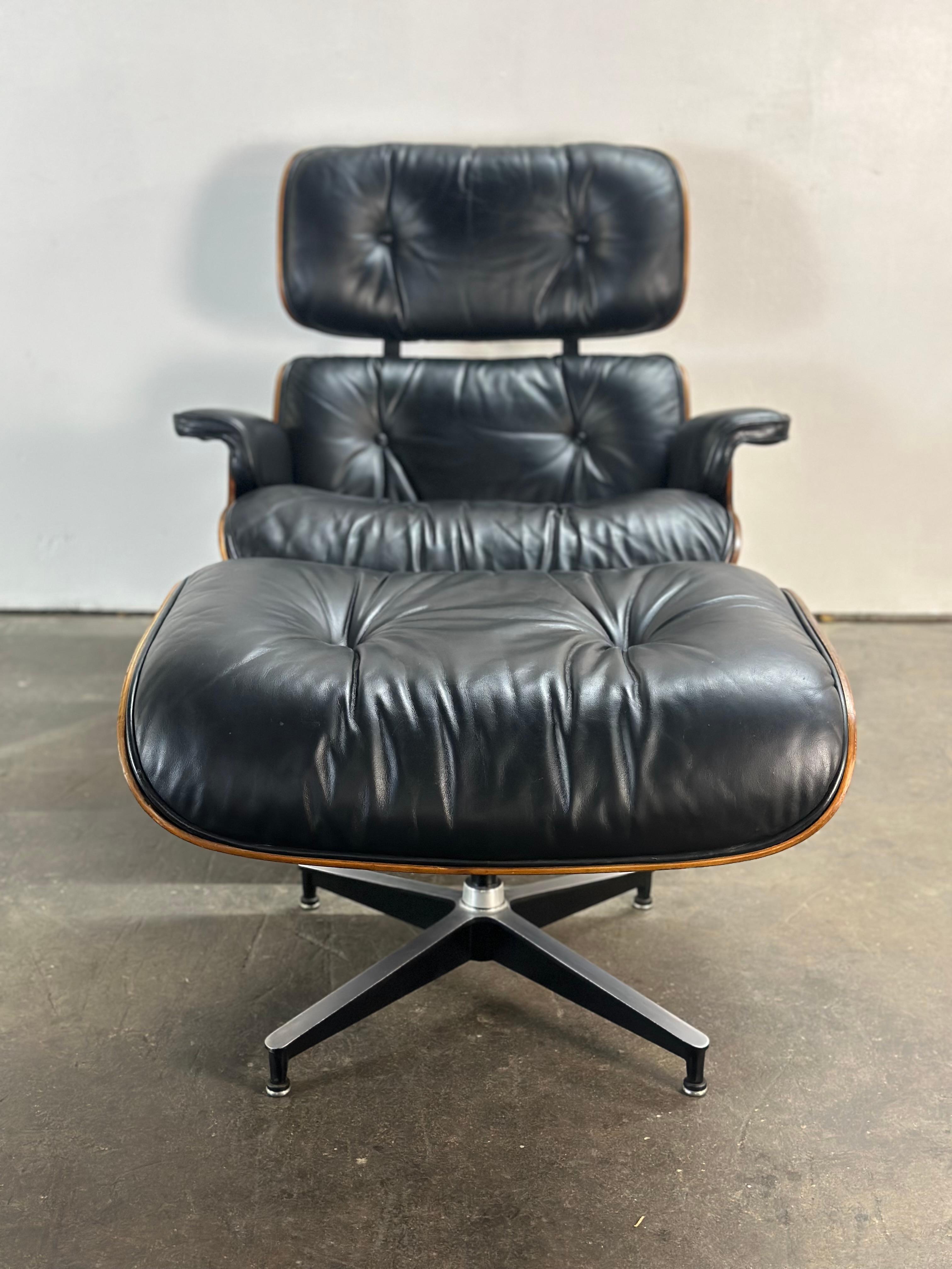Beautiful 1970s edition Herman Miller Eames lounge chair and ottoman. Finished in Brazilian rosewood with black leather aluminum structural accents. Chairs swivels on base. Chair and ottoman have been carefully restored to beautifully display the
