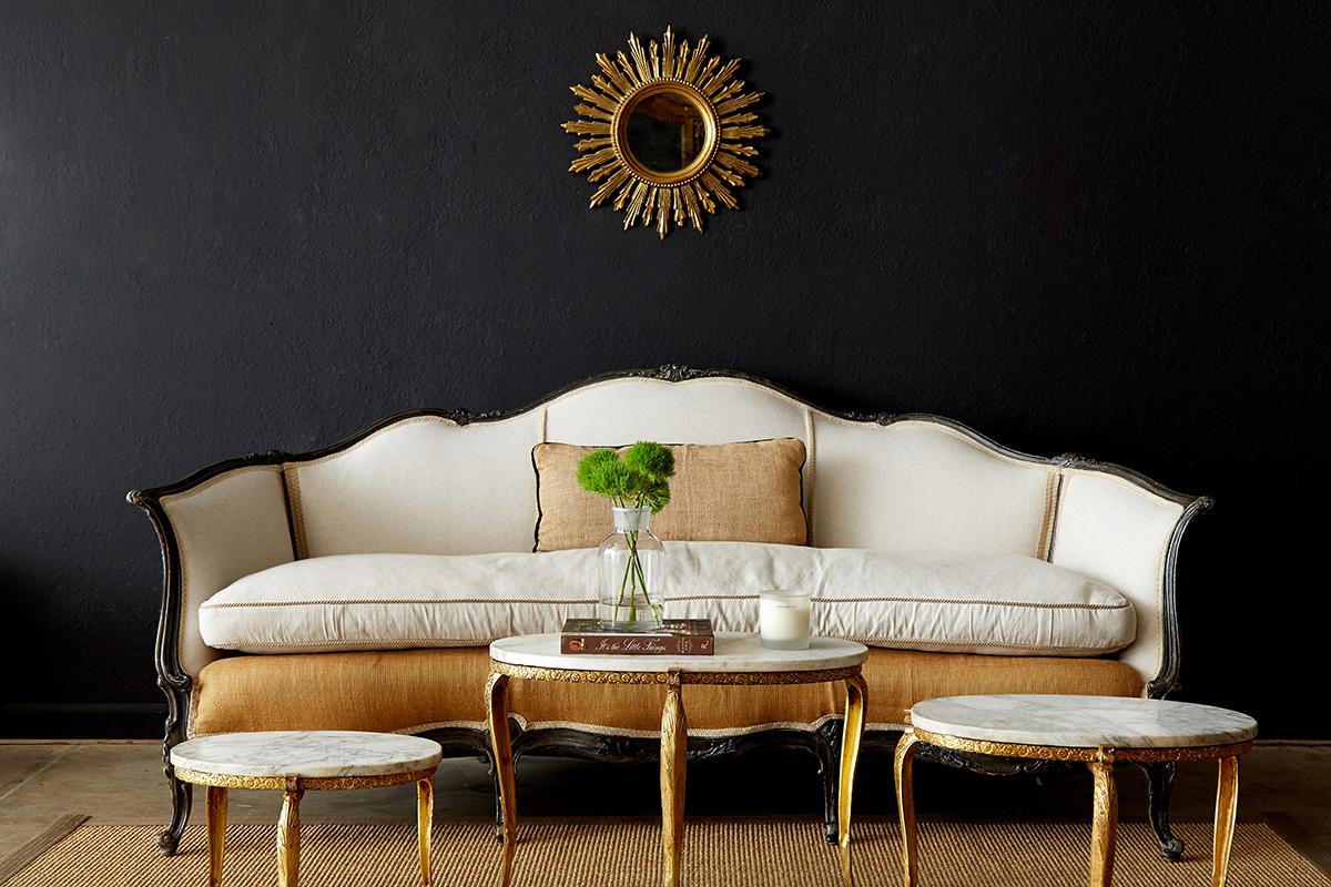 Grand 19th century French canapé sofa made in the Louis XV taste restored with new recent upholstery. The frame is covered in burlap and French linen with a thick linen cushion. The highly carved frame features an ebonized finish with a beautiful