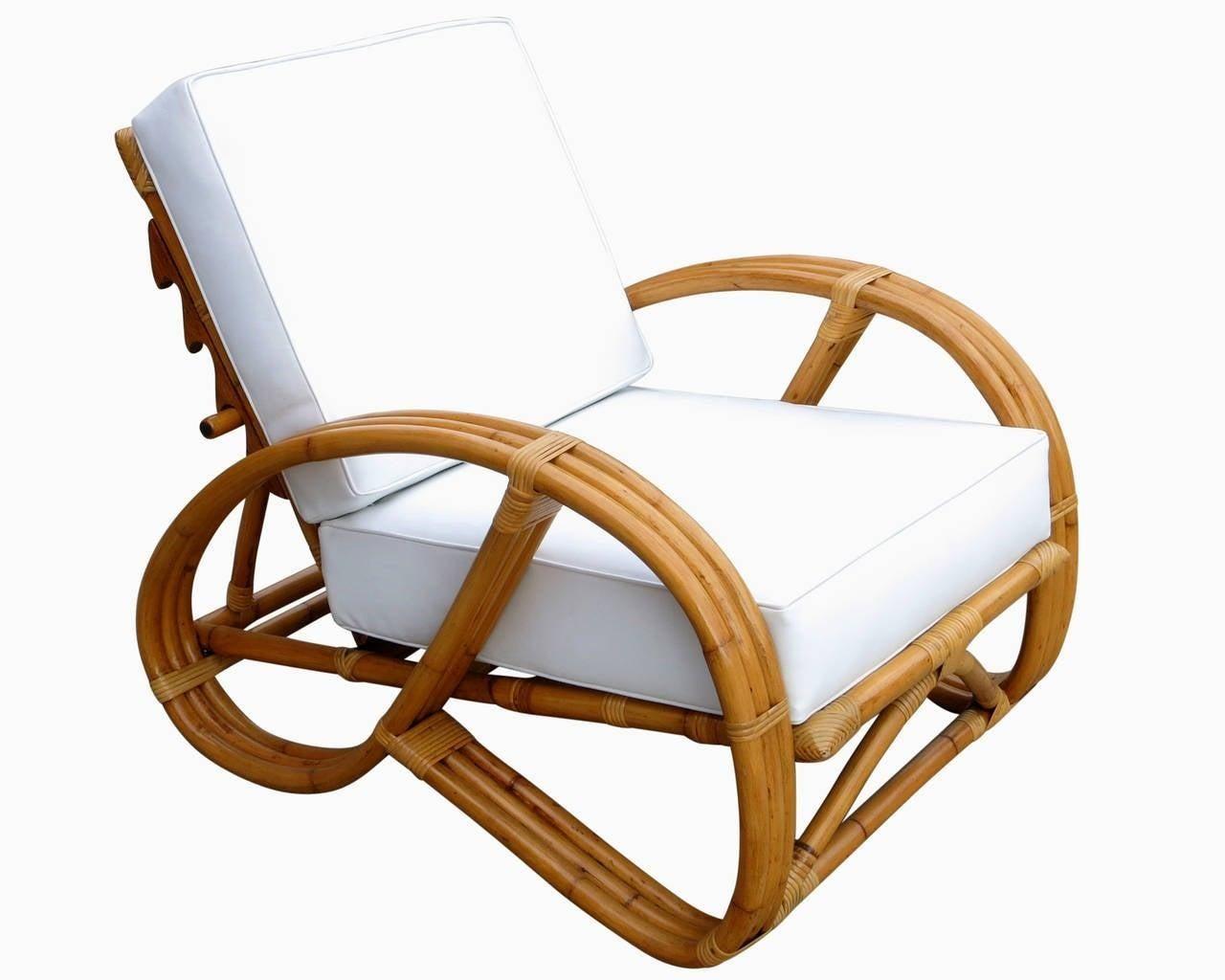 This rare rattan reclining lounge chair with 3/4 Pretzel arms arch-shaped base. The accompanying bent rattan ottoman features three-strand U-shaped legs with matching wave detail.
1950, United States
Measurements
Chair: 32