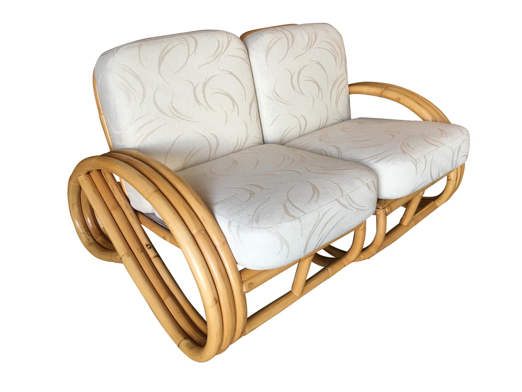 Restored 3 stranded 3/4 pretzel arm, rattan 2-seater sectional sofa with line base. Comes with wedge end/drink table and can be configured in several arrangements. 

Inspired by Paul Frankl this lounge is one of the rarest of all designs. The