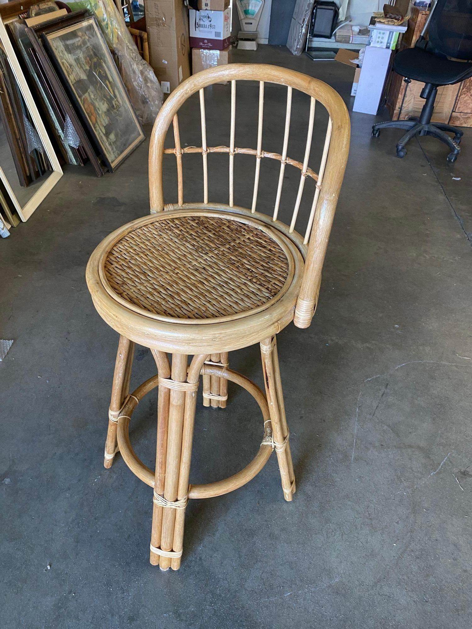 Rattan bar stool with woven wicker seats and 3-strand rattan pull legs. The stool comes with a fully formed backrest complimented by arches connecting each leg.  

Measures: Height- 38
